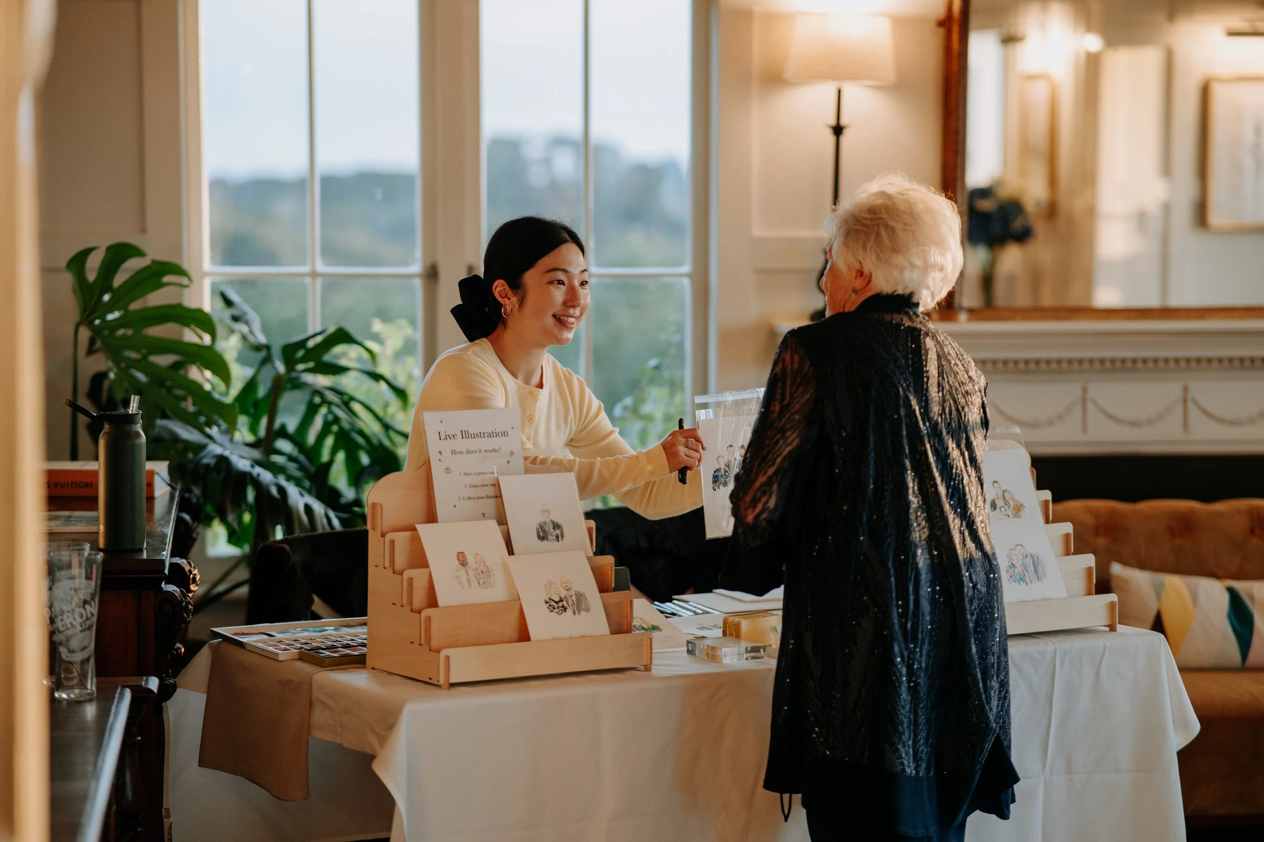 Guests receiving their live illustration portraits at a wedding