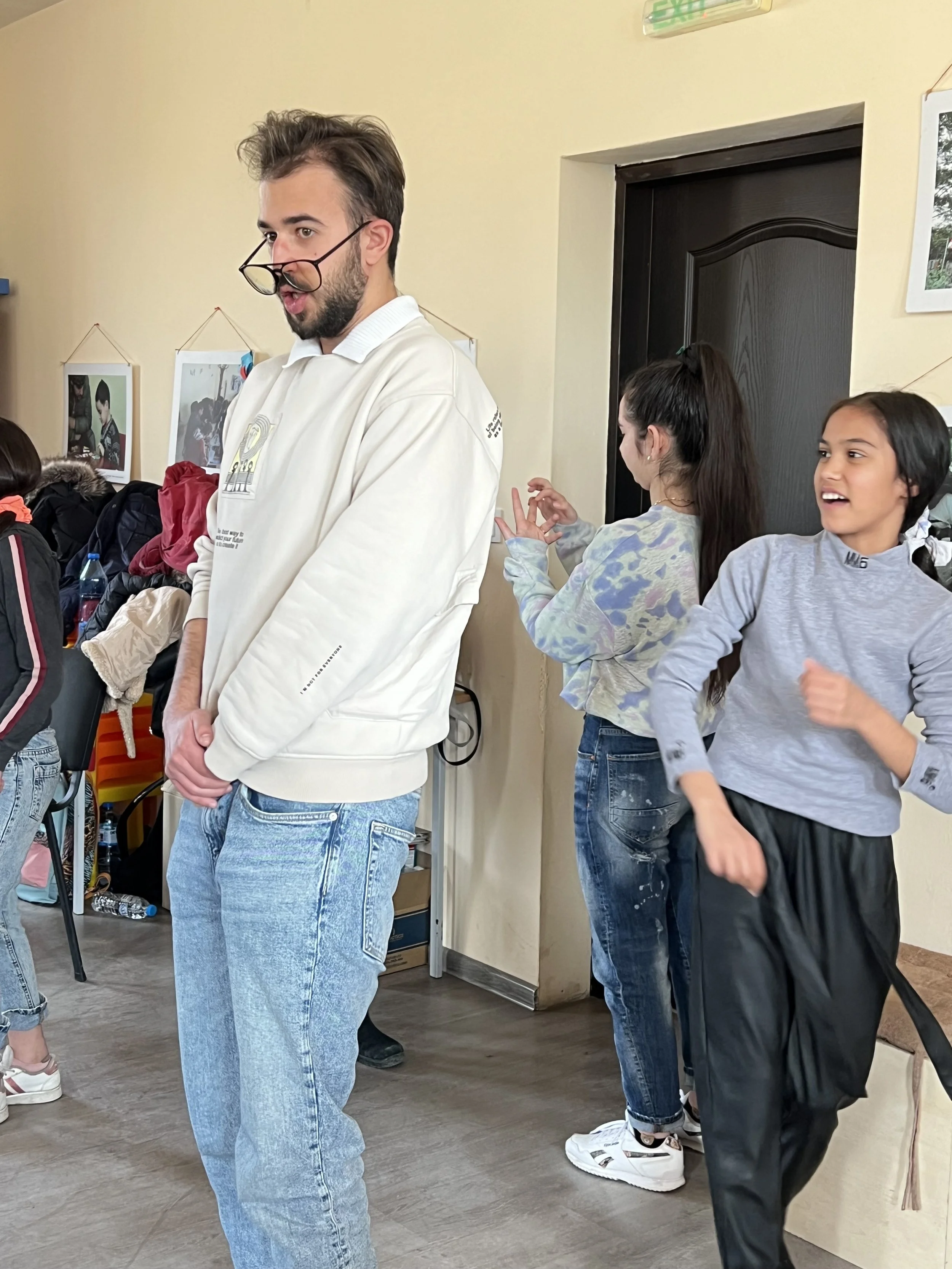 university student conducting acting exercise with class