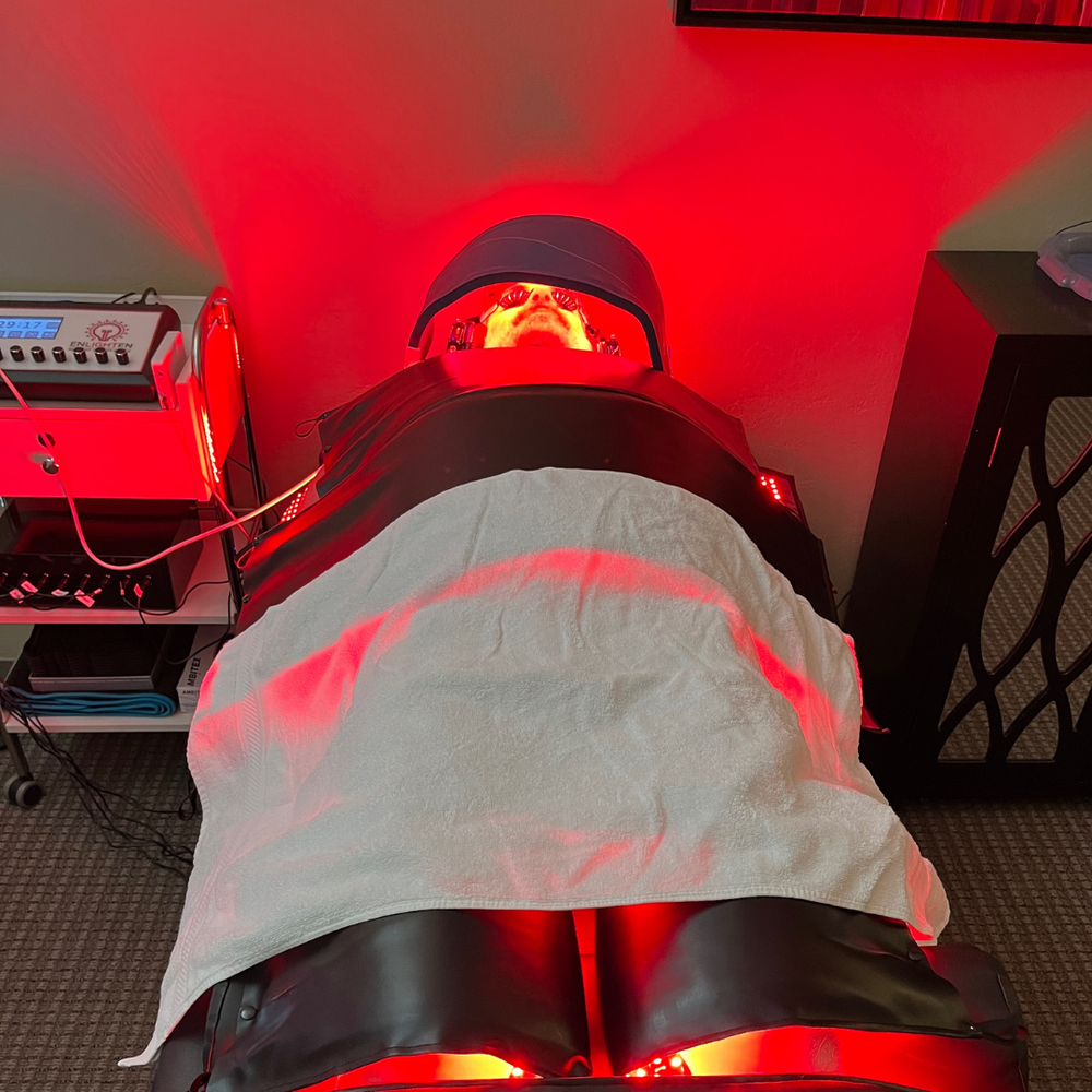Person applying moisturizer after red light therapy session