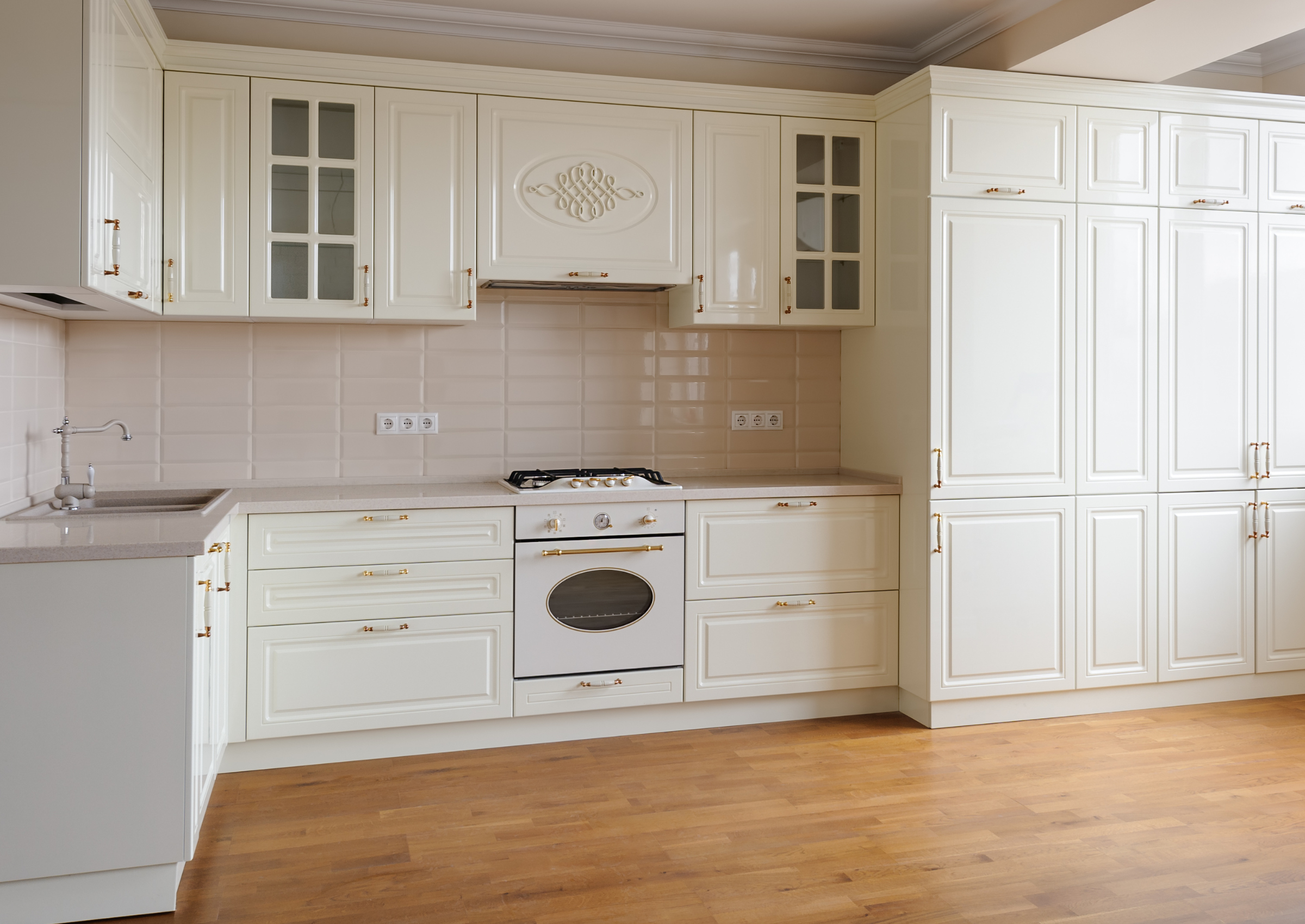 Off-white traditional kitchen remodel with detailed cabinetry and gold hardware, demonstrating timeless design for long-term home investment