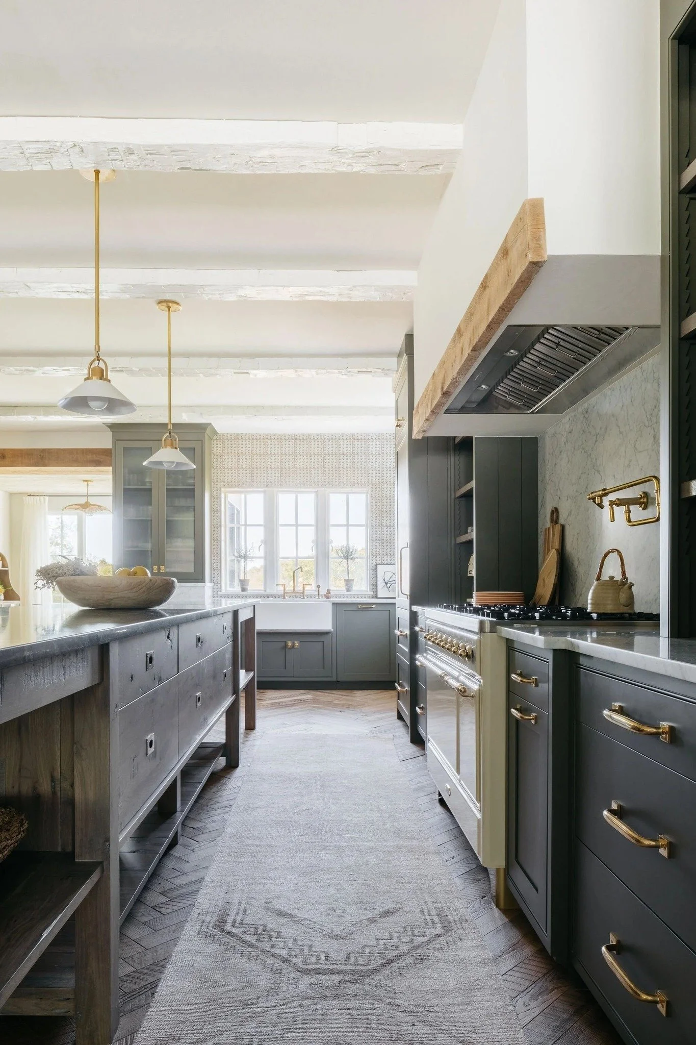 Design lives in the details: how cabinetry frames a window, how light softens across painted finishes, how mixed materials create rhythm in a room. Here, warm oak contrasts painted millwork for quiet balance. Brass hardware adds warmth, while clean l