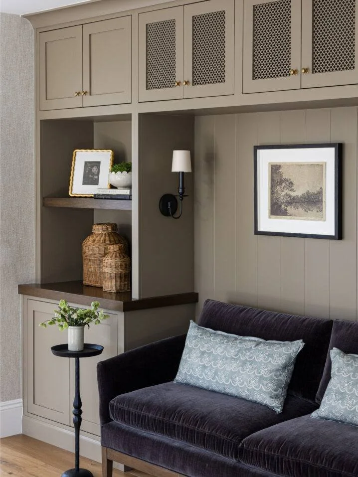 Sleek built-ins and tailored cabinetry define this space: matte brass hardware, paneled texture, and quiet tones that layer warmth with sophistication. A reminder that every inch of millwork can be both functional and refined.

Like what you see? Tap