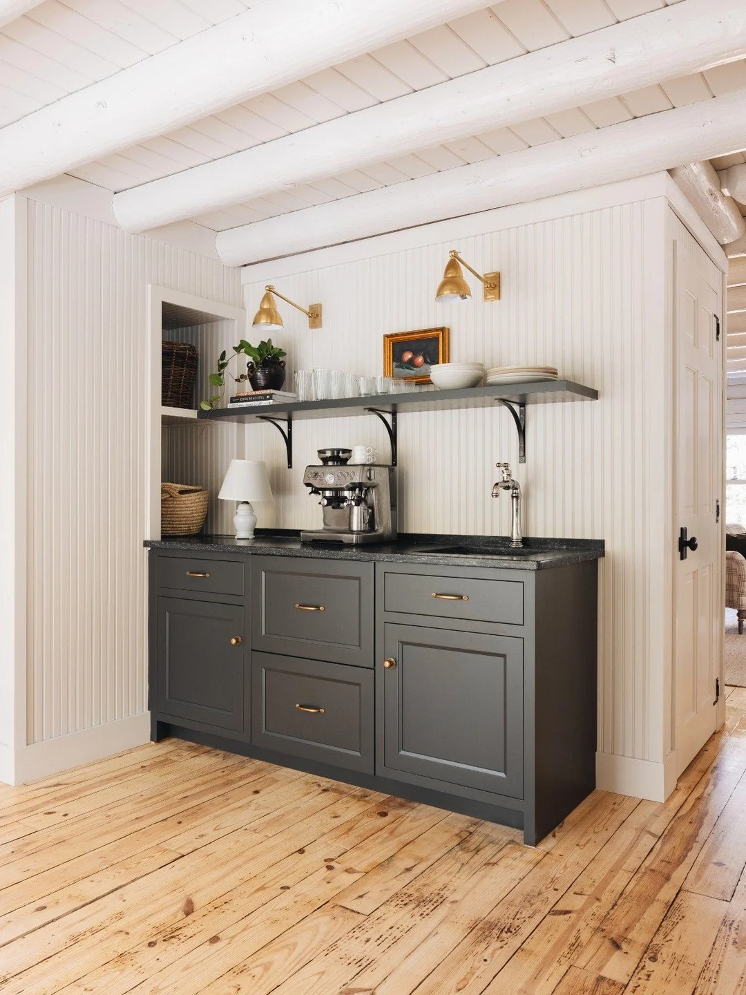Swipe for a closer look at thoughtful details. ➔ ➔  A dedicated coffee station framed by paneled walls, warm brass lighting, dark stone countertops, and cabinetry that feels grounded and intentional.

Every drawer has purpose. Every finish supports t