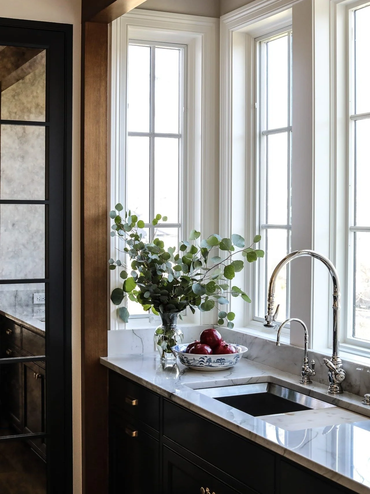 Swipe to see the arched range detail and window framing up close. 🖤
Moody inset cabinetry. Full-height marble with soft veining.
A true slab waterfall island.
Unlacquered brass that will age beautifully.
This is how you make a bold kitchen feel time