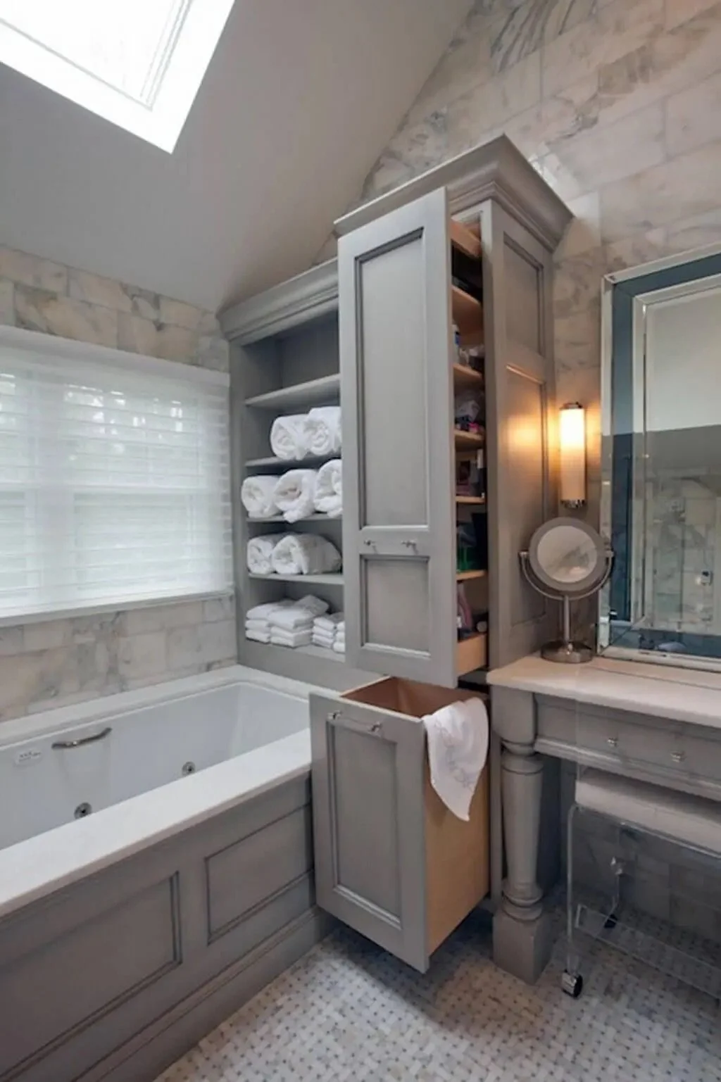 Built-in bathroom cabinetry with open shelving and tall storage cabinet for towels and toiletries, designed for functional and timeless bath organization.