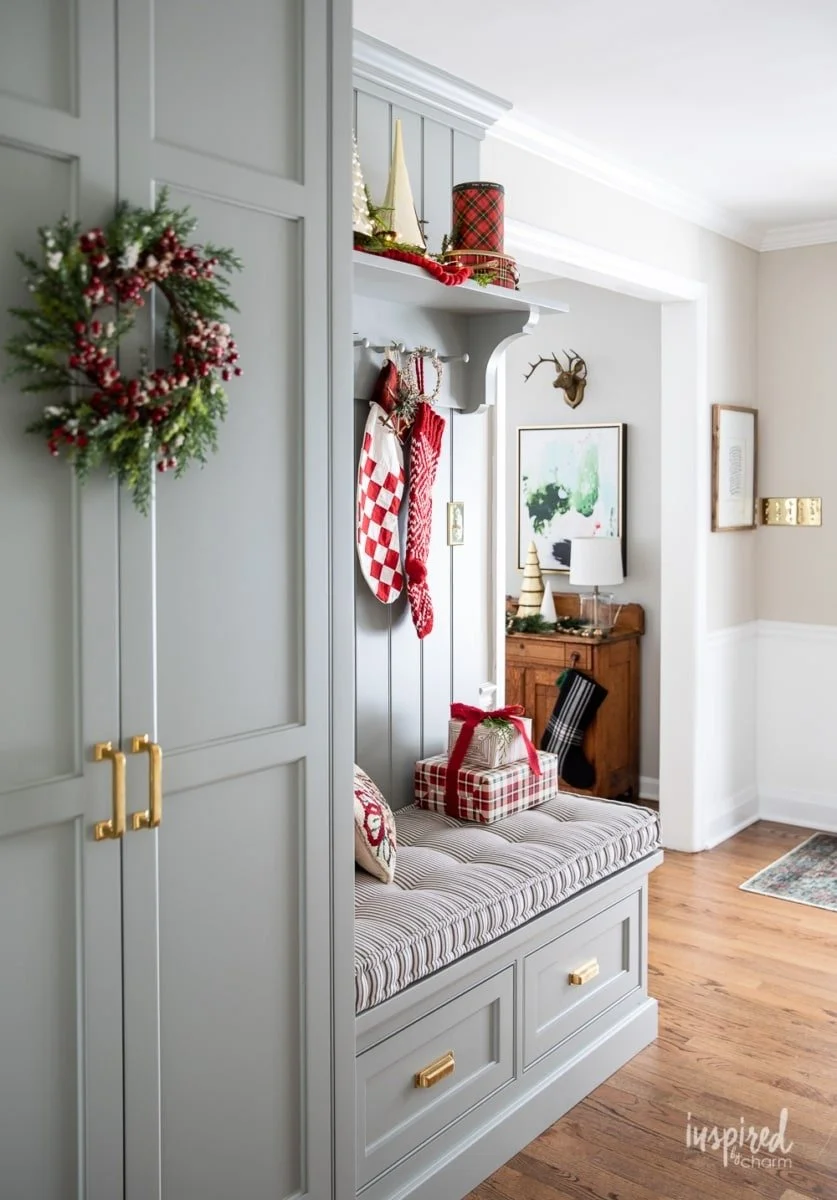 Custom built-in entryway cabinetry with bench seating and holiday decor, designed for functional storage and timeless style by a professional cabinetry company in Georgia.