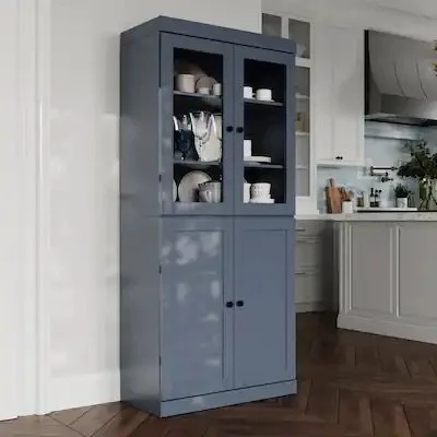 Standalone shaker pantry cabinet with glass doors positioned separately from kitchen cabinetry