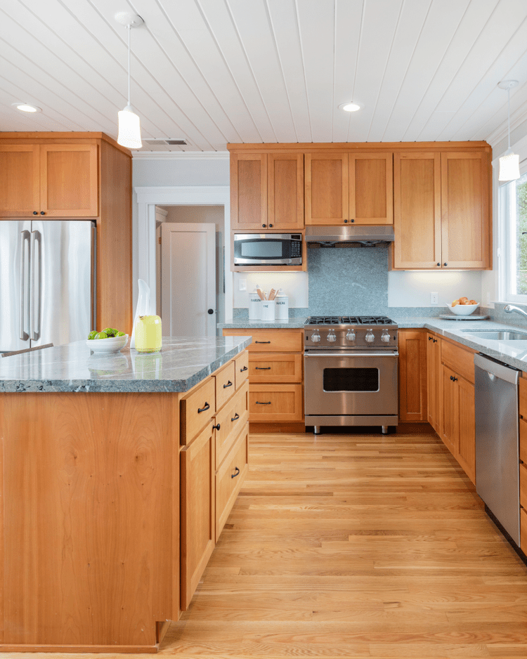 Warm wood kitchen island with RTA cabinetry and storage designed by Hester Family Millwork