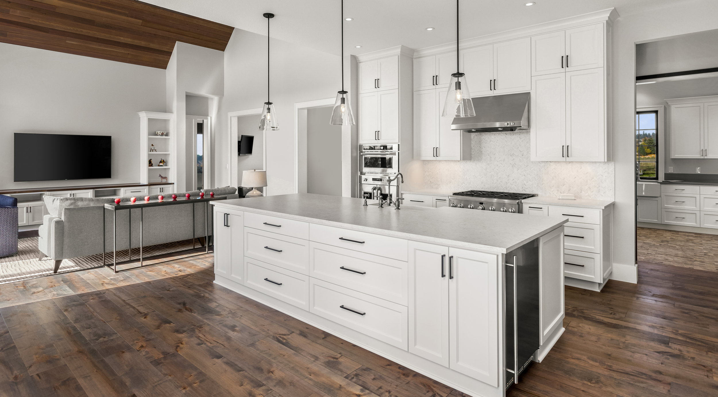 White shaker kitchen cabinets with dark hardwood flooring, open concept layout, and large center island in a modern timeless kitchen