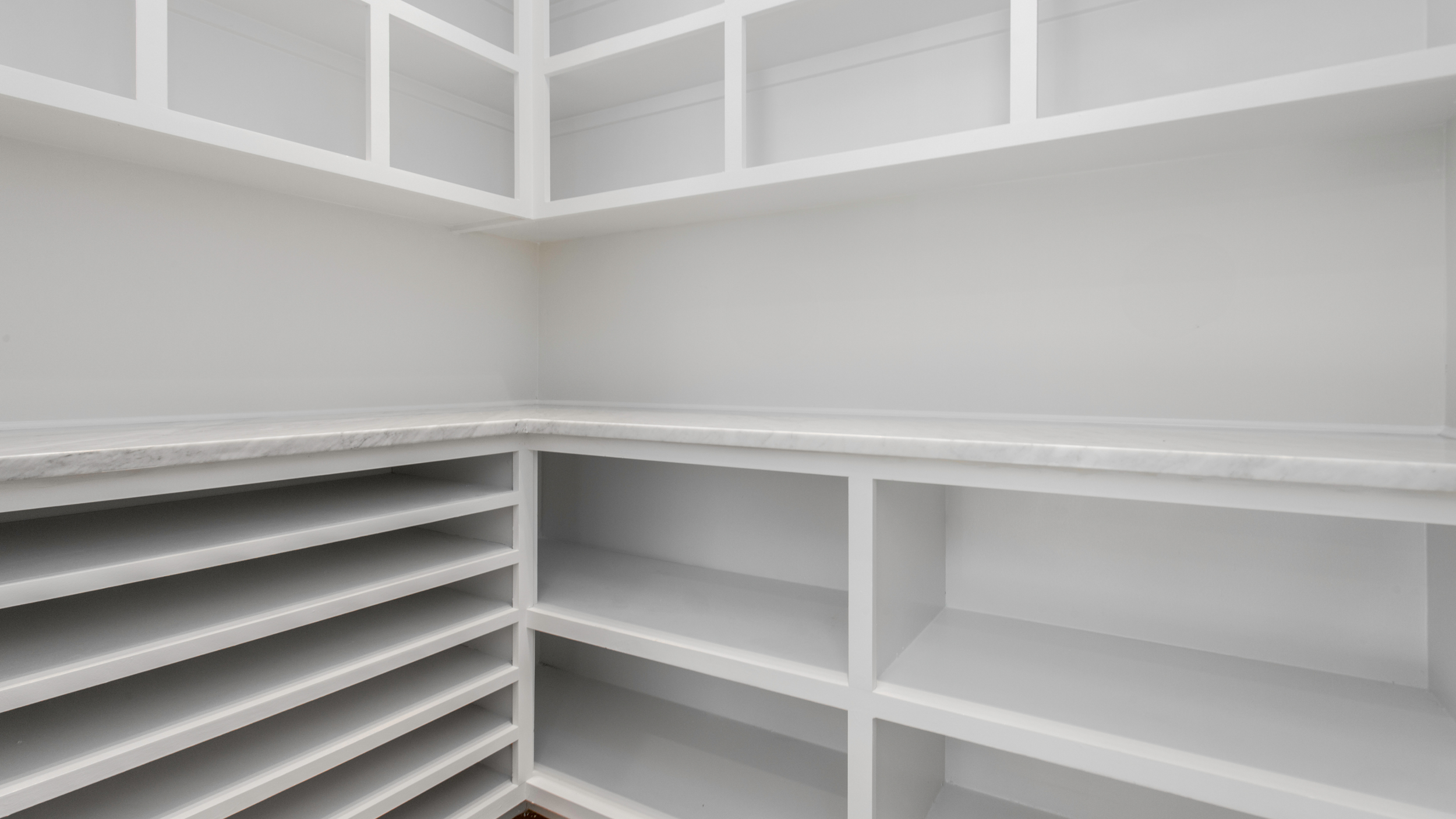 Walk-in pantry cabinets in North Georgia with built-in shelving and organized storage by Hester Family Millwork