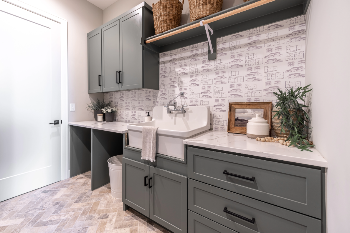 Gray mudroom cabinets with long black pulls and patterned backsplash showing correct hardware scale.