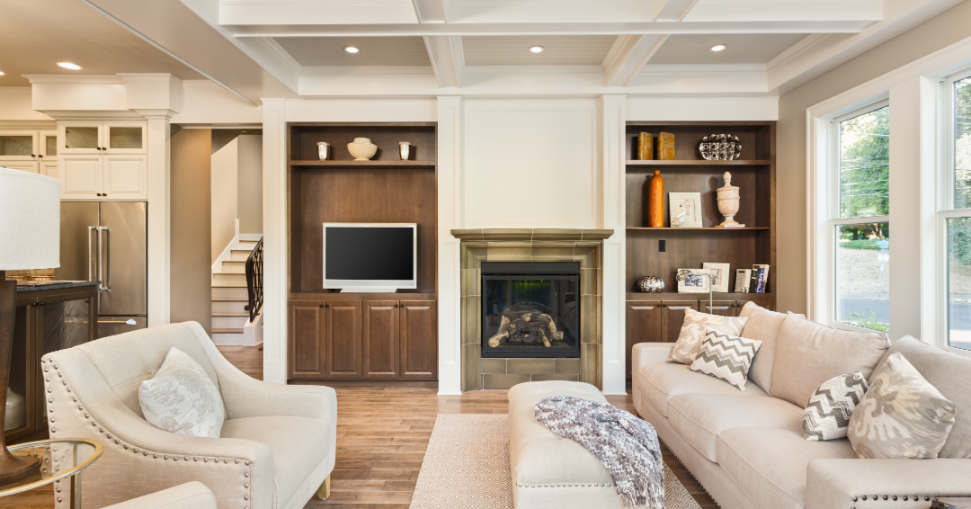 Custom living room built-ins with rich wood cabinetry, open shelving, and a fireplace surround that demonstrate timeless millwork design and lasting warmth.