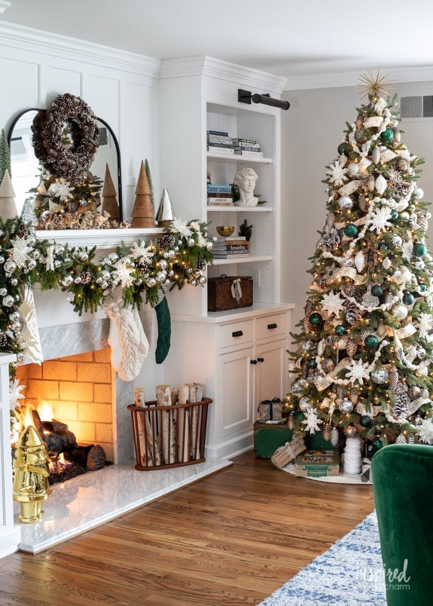 Custom living room built-in cabinetry with fireplace surround and shelving, styled for Christmas with garland, stockings, and a decorated tree, showcasing timeless millwork and functional storage.
