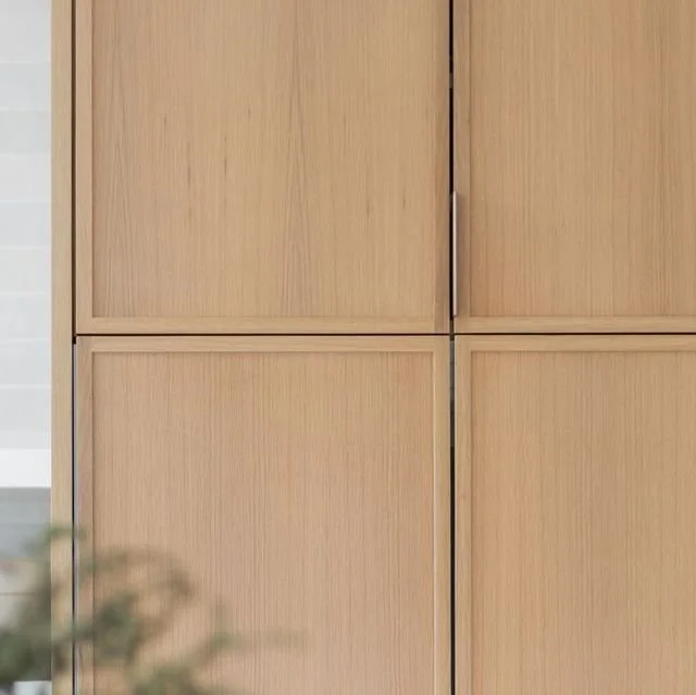 Micro shaker white oak cabinet doors with slim profiles and minimal hardware, showcasing modern cabinetry design with clean lines and natural wood texture.