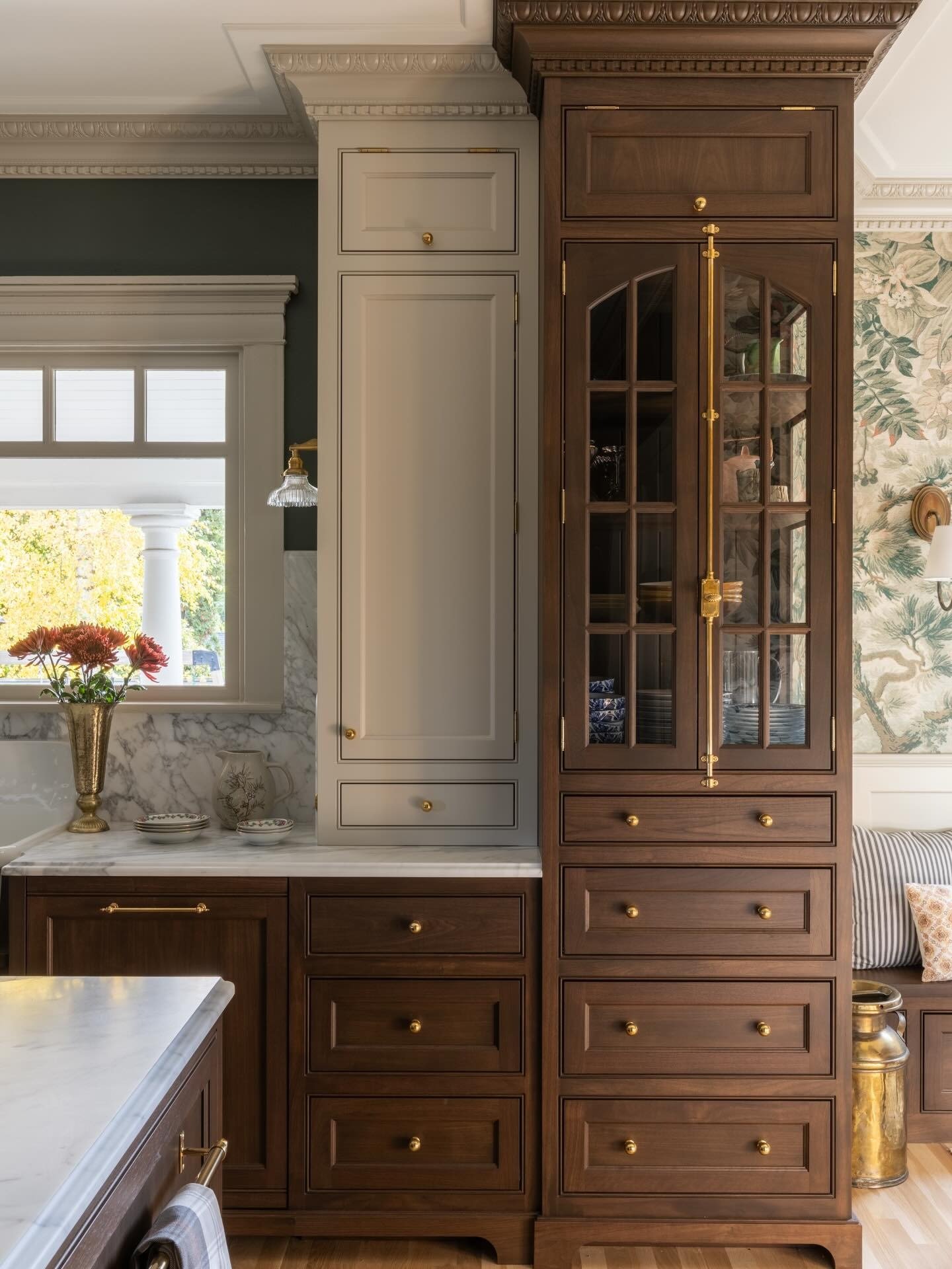 Custom kitchen cabinetry featuring warm wood cabinet doors, inset drawer fronts, glass front storage cabinets, and brass hardware, showcasing timeless cabinet door styles designed for long lasting home remodels.