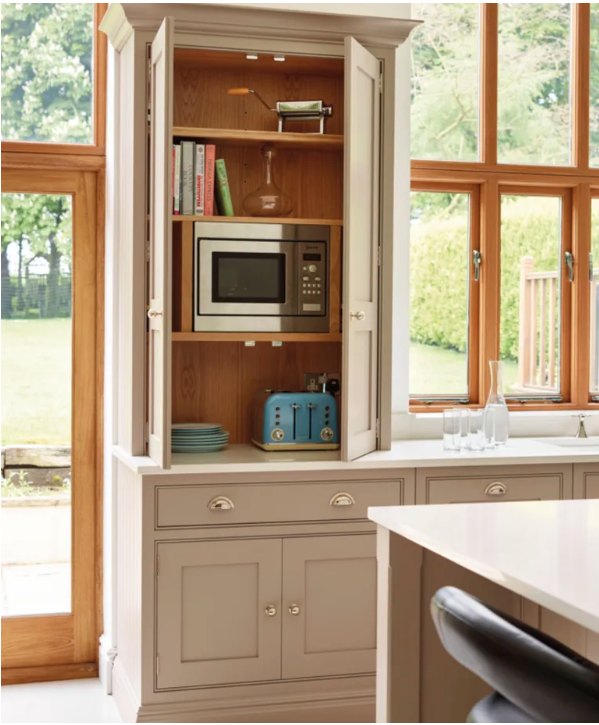Custom appliance garage cabinet with concealed coffee station, built-in storage drawers, and integrated shelving for small kitchen appliances in a luxury transitional kitchen.