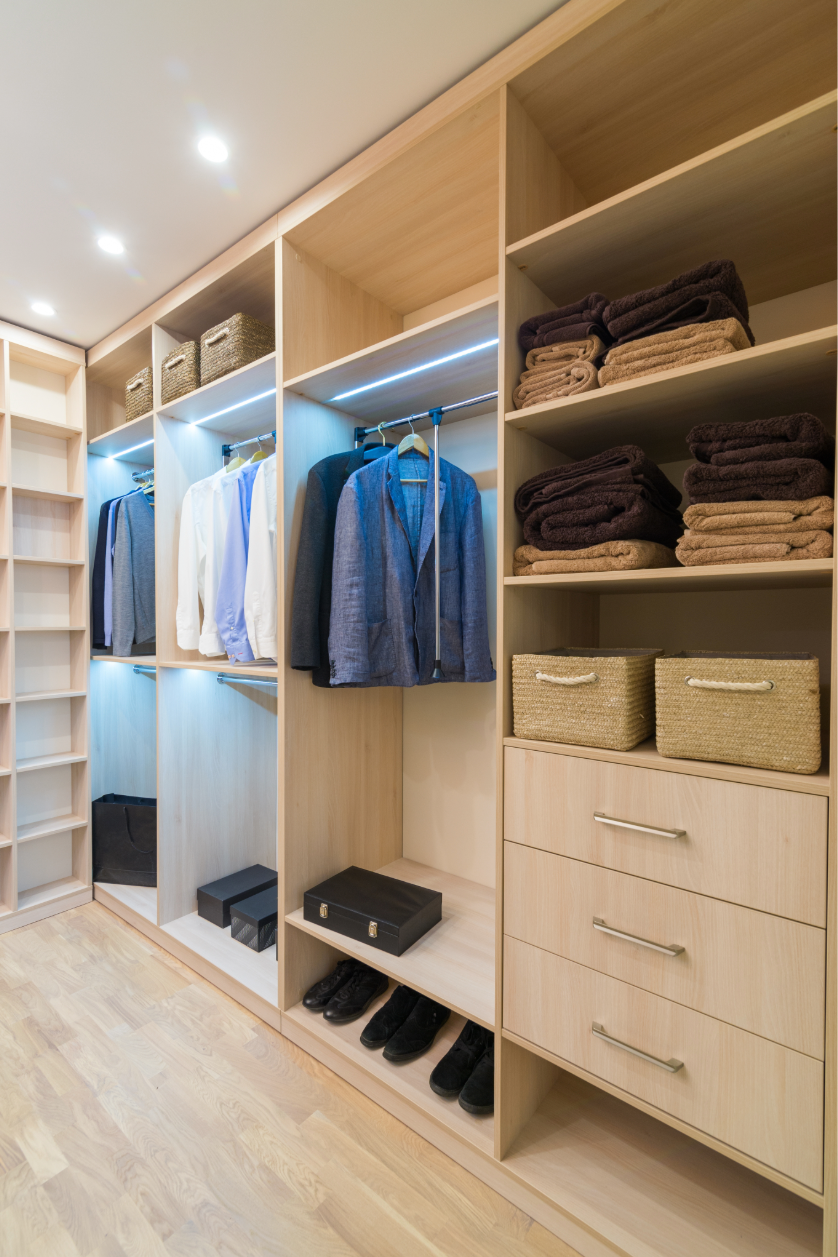 Custom light wood closet system with hanging space, shoe storage, drawers, and built-in shelving designed by Hester Family Millwork in Georgia.
