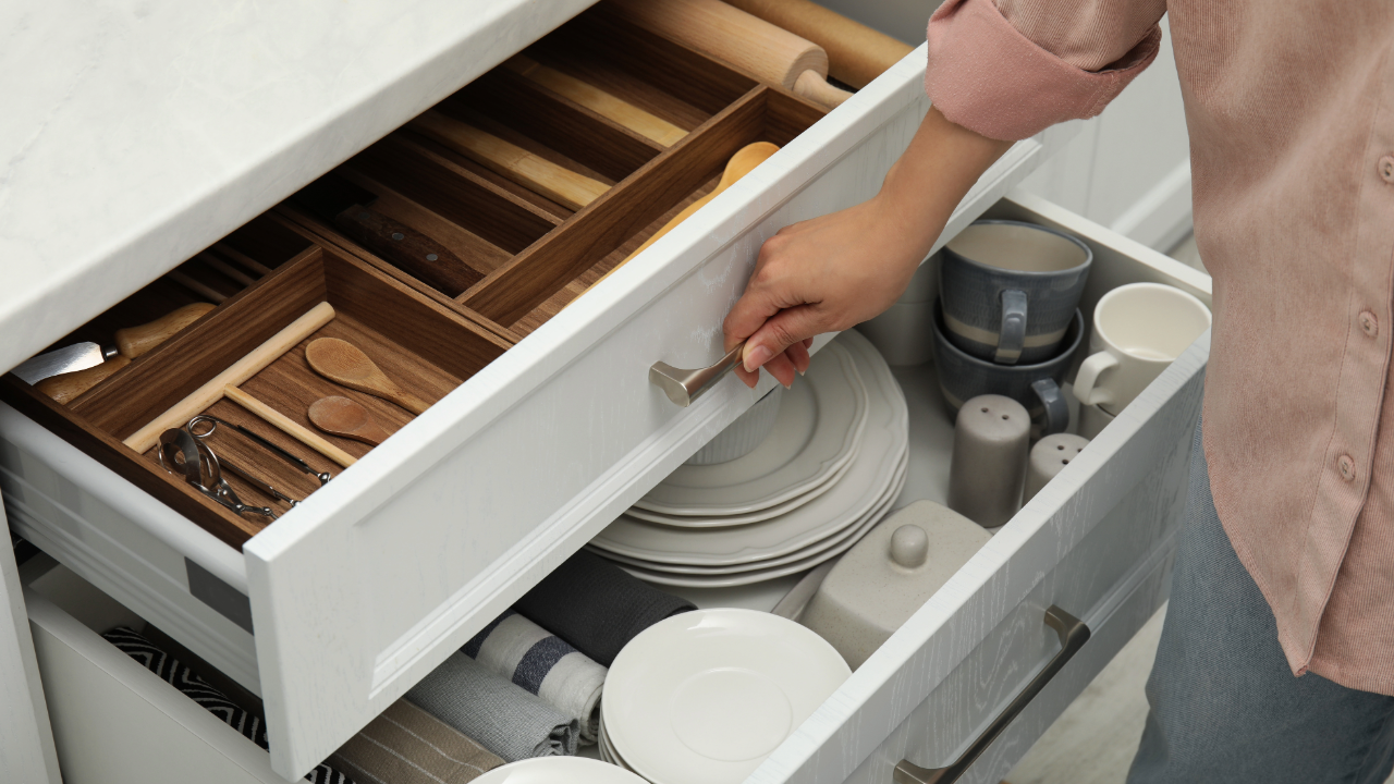 Kitchen cabinetry with deep drawers and custom wood organizers, showing efficient storage for dishes, utensils, and everyday kitchen items in a clean, functional layout.