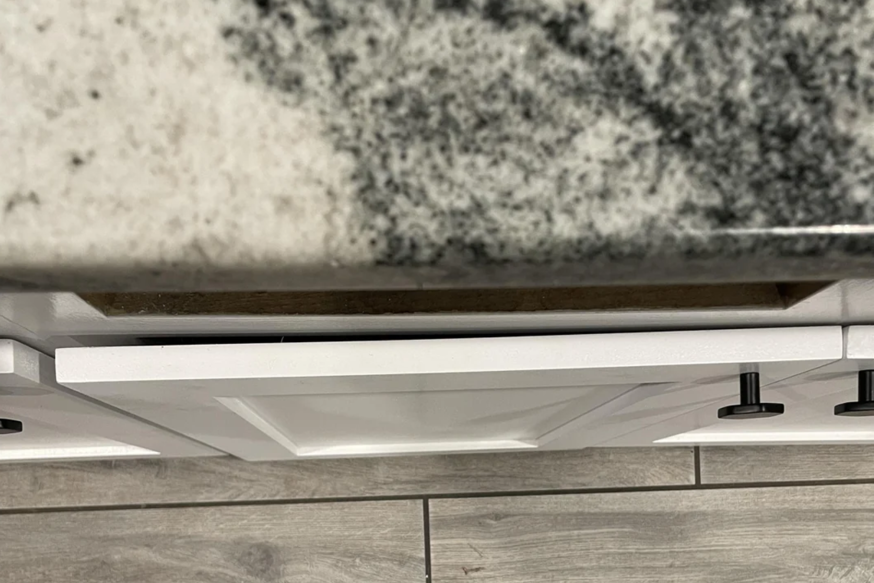 Cabinet drawer misaligned and sticking open.