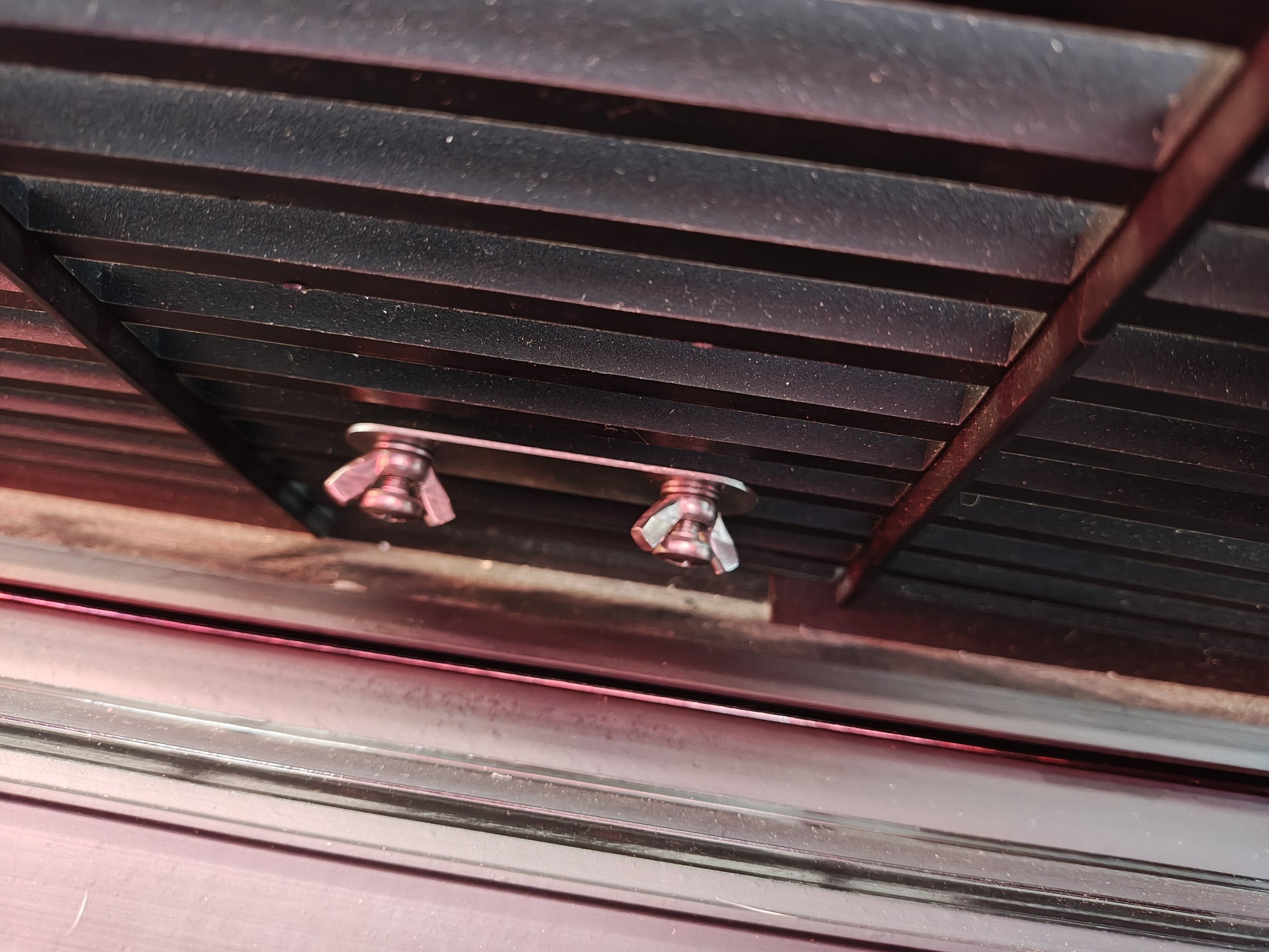 This is what it will look like on the back side.  I did use one of the original screws to initially line up the badge.  Then I screwed in the plate, 25mm screw, wing nut, and washer into the other side.  Once I got that snug, I removed the original l