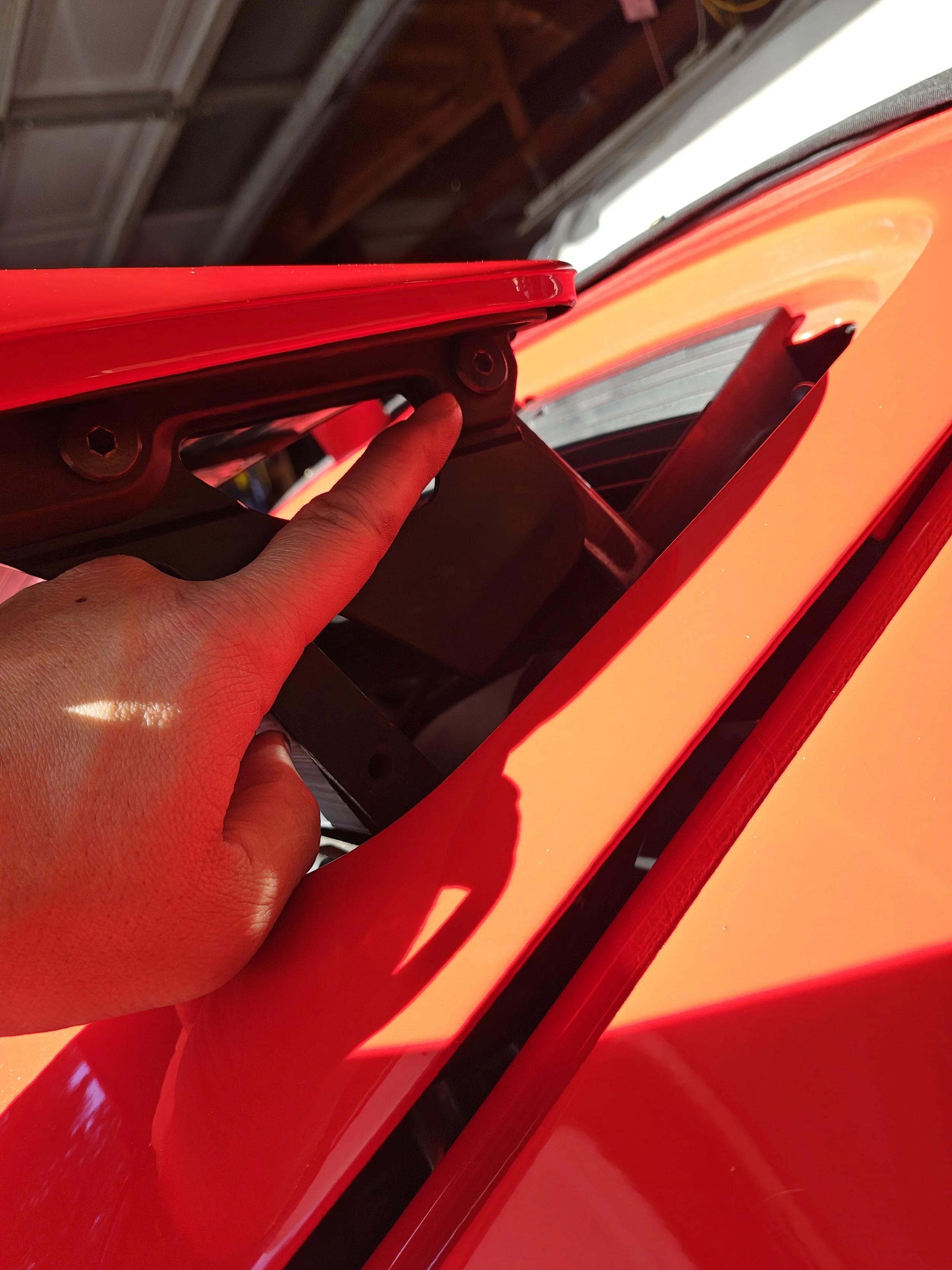 For easiest access to the under side I suggest removing this screw on both sides.  You'll need a 5mm Allen wrench, bit or socket.  I used a 5mm Allen socket. 