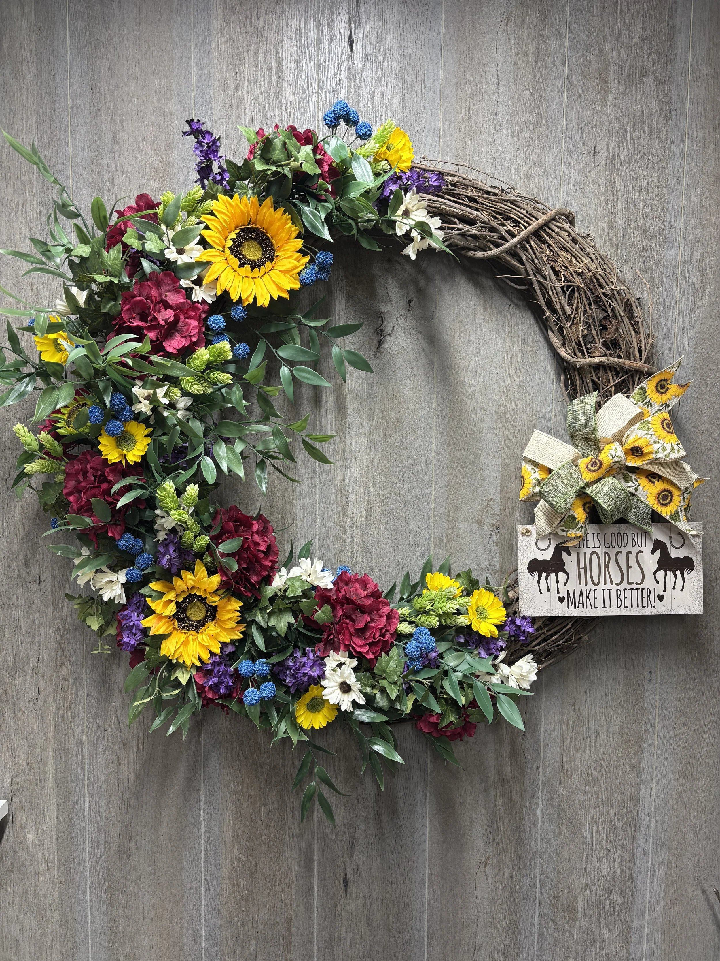 Wreath - Assorted floral colors with wood sign.  Shipping extra.