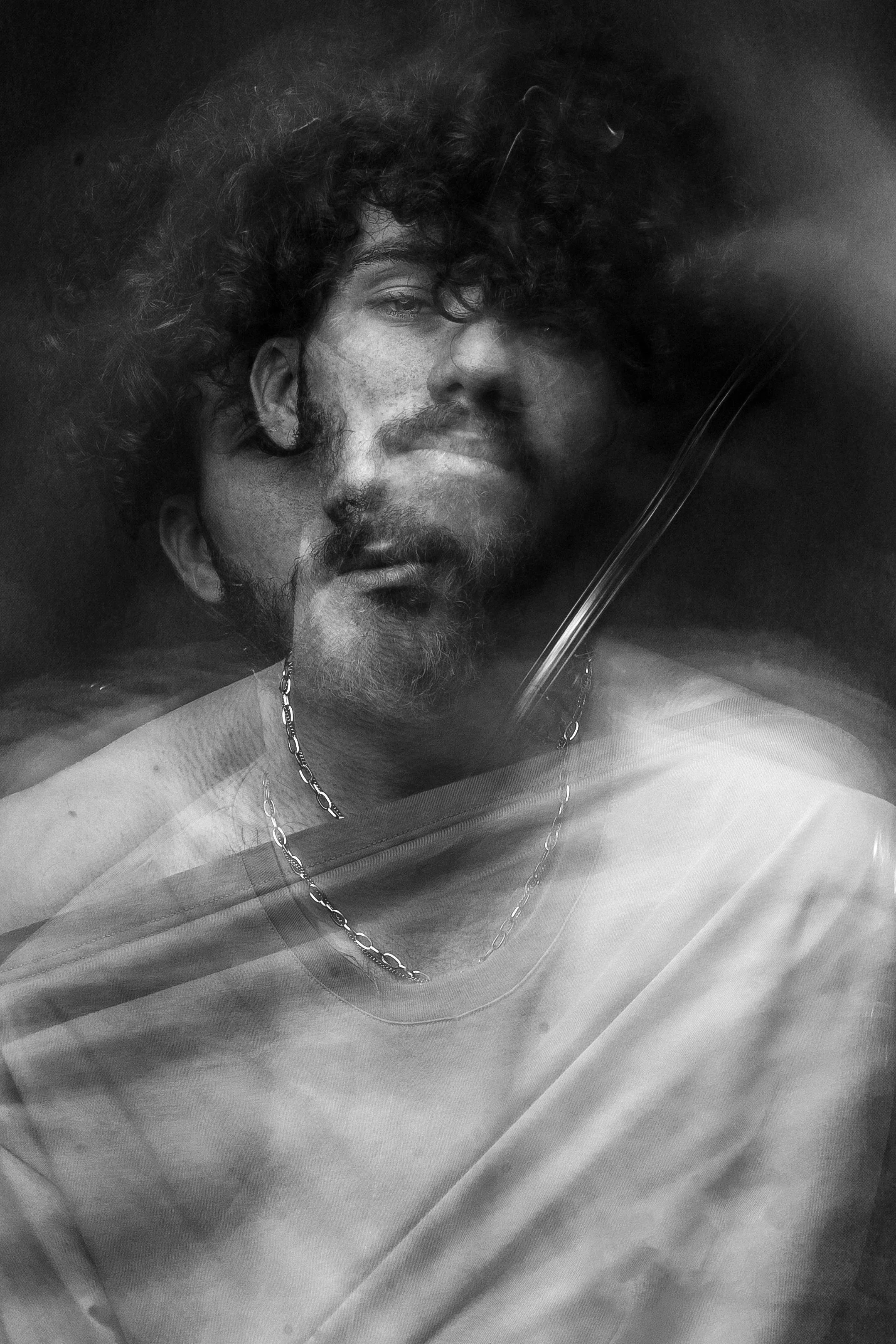 A blurred double-exposure portrait symbolizing the inner confusion and emotional struggle that can stem from unmet needs in one’s family of origin.