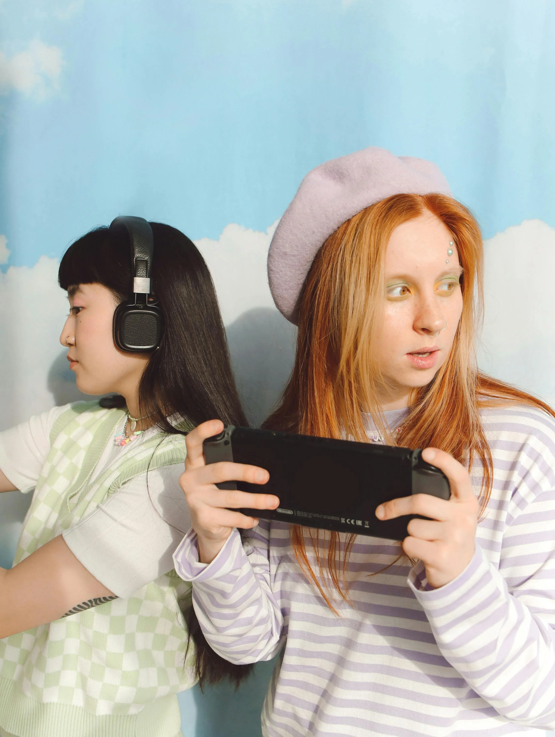 Two young people absorbed in their devices, symbolizing the comparison, distraction, and anxiety fueled by social media and FOMO.