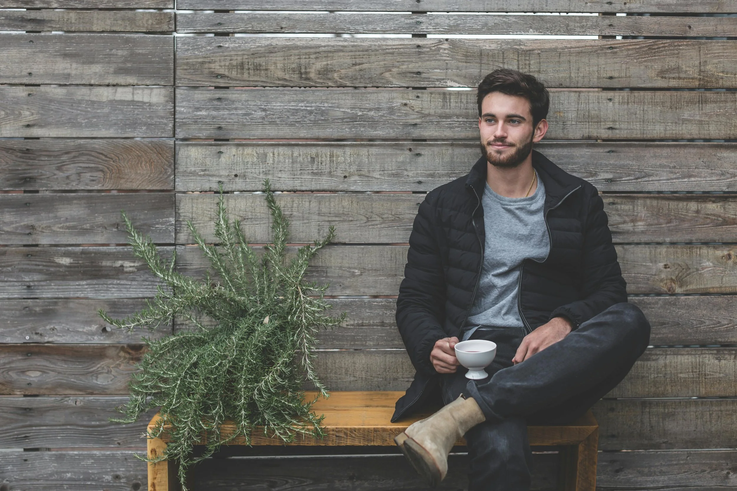 A man sitting calmly with a cup in hand, symbolizing the steady self-reflection and support therapy offers in overcoming the fear of failure.