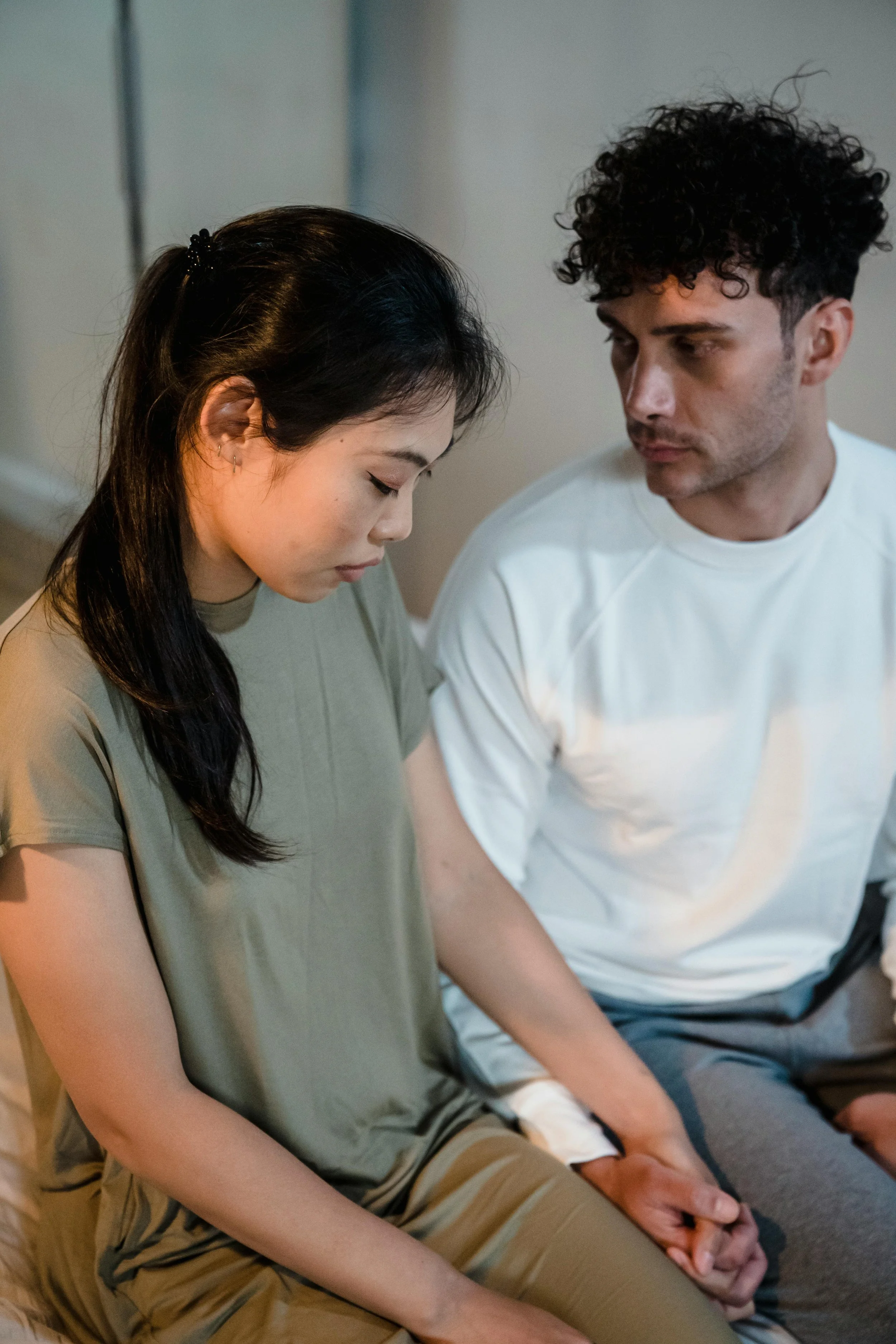 Couple sitting together in a moment of emotional tension, illustrating relationship communication challenges and therapy support in San Francisco