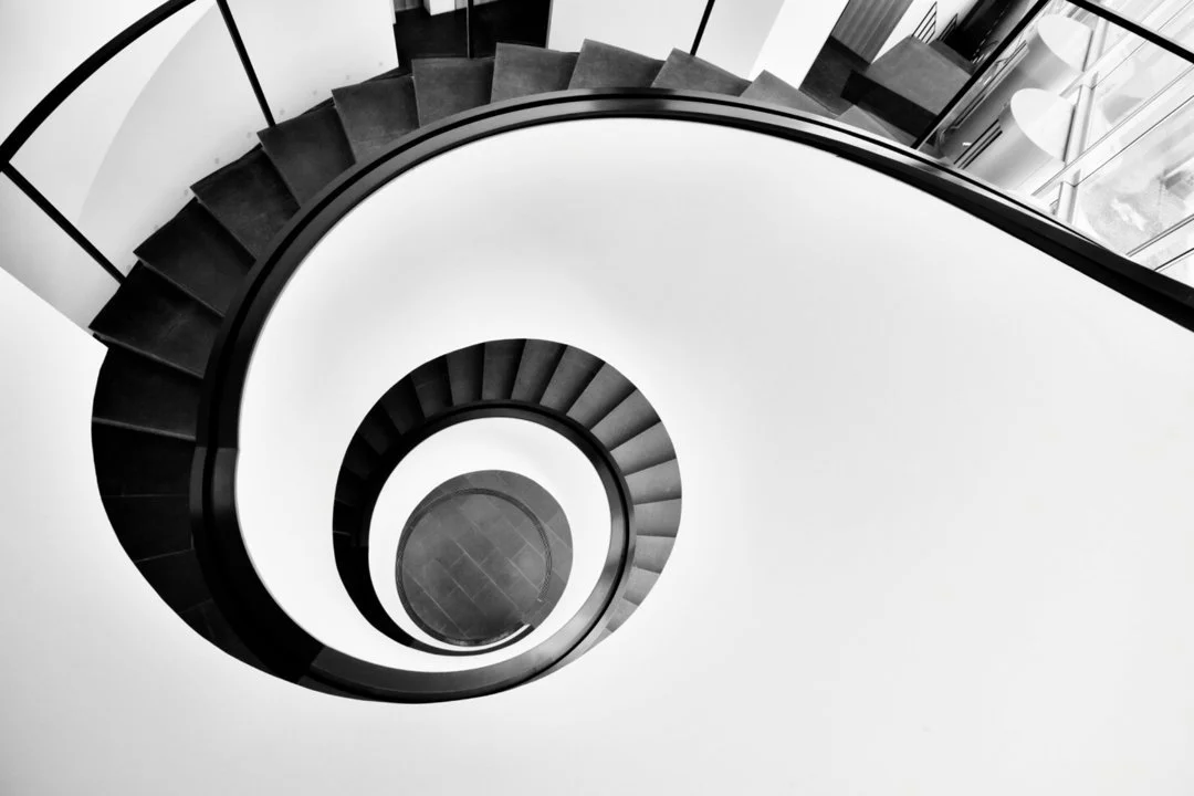 Black and white spiral staircase symbolizing the emotional twists and turns people face when friendships change or drift apart