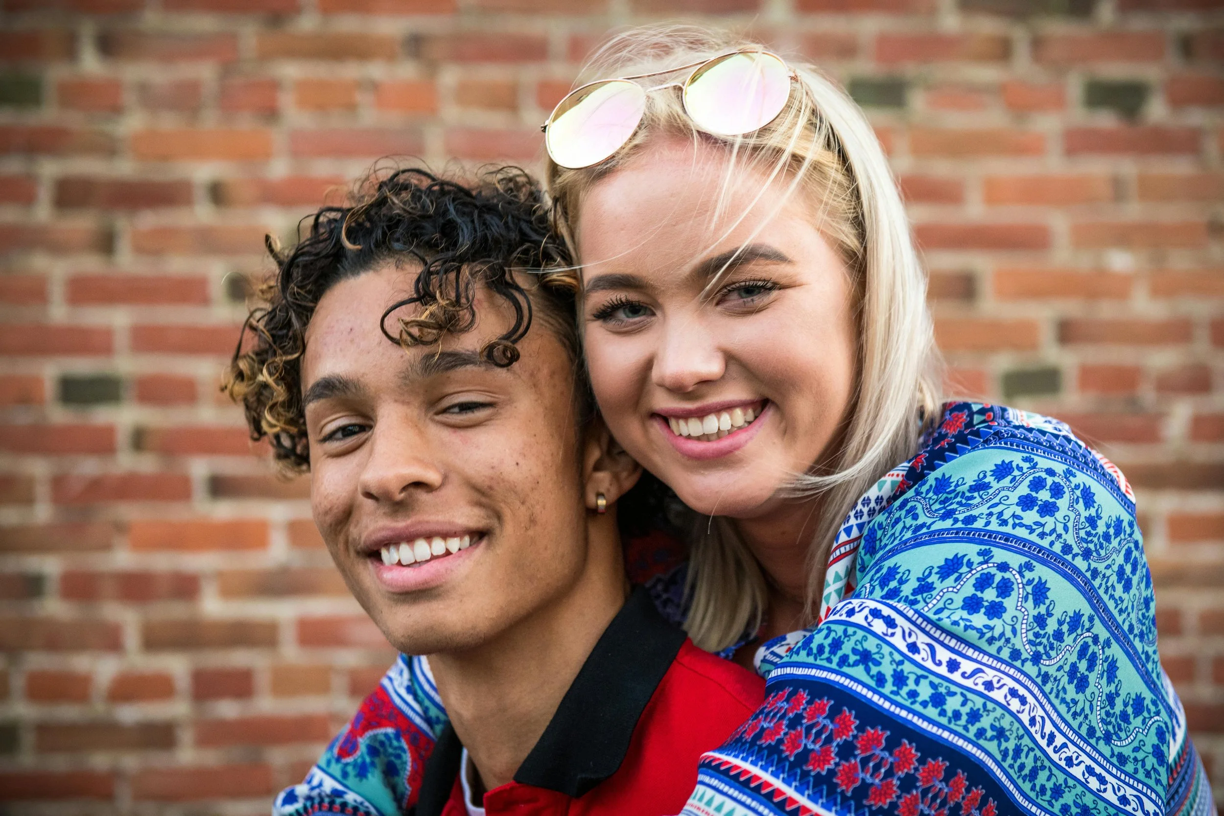 Interracial couple smiling and embracing outdoors — relationship healing and emotional recovery, therapy support in San Francisco.