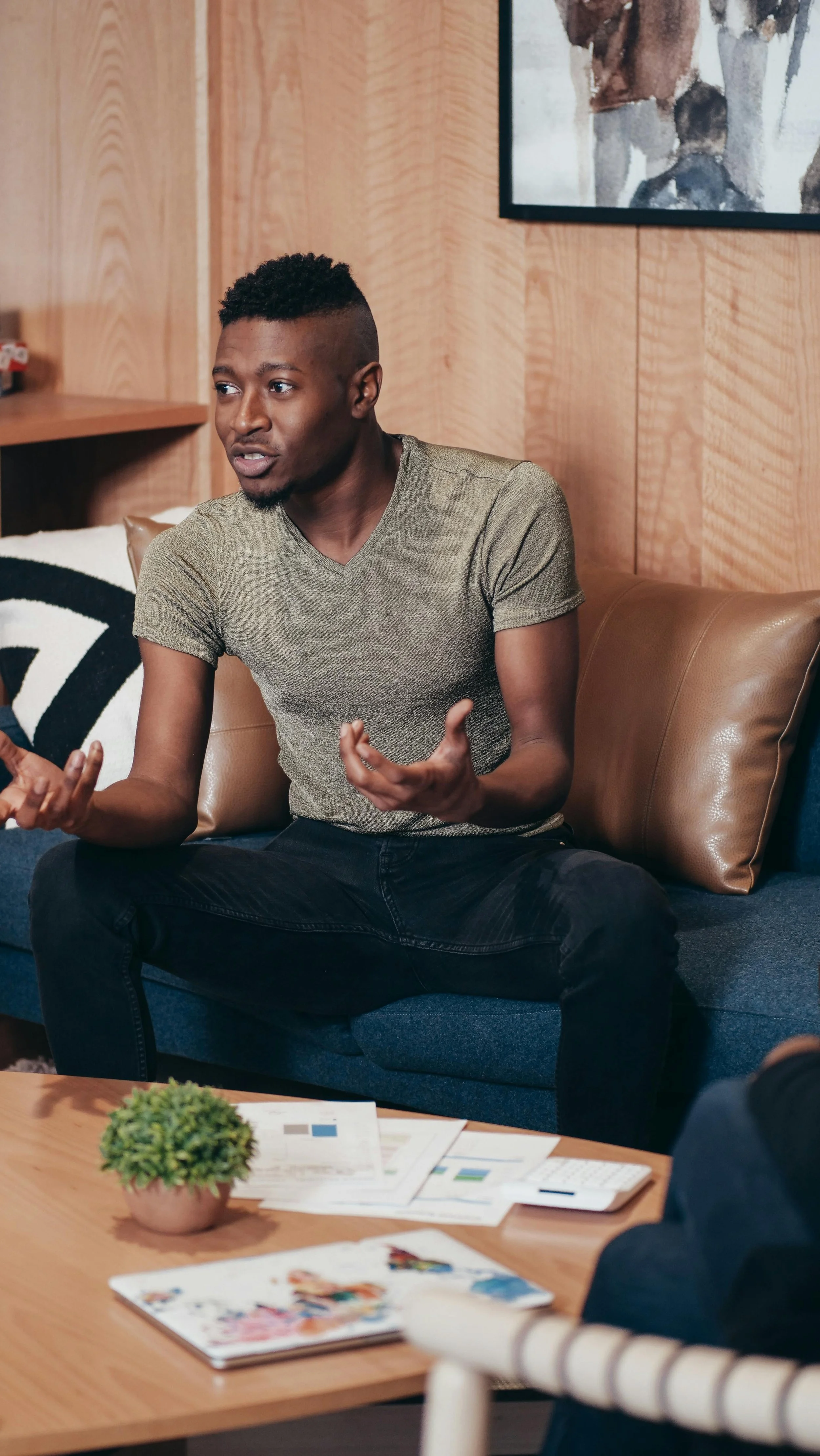 A person speaking openly in a therapy session, symbolizing the healing process of addressing race-based traumatic stress through psychodynamic work.