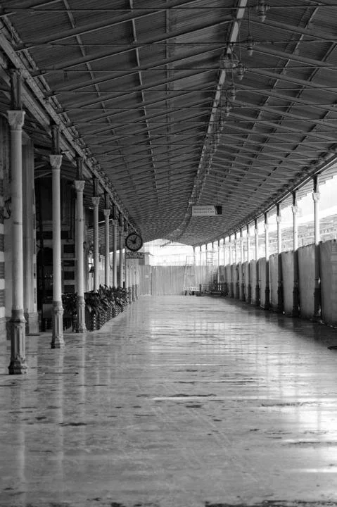 Empty corridor with repeating columns and reflective floor, symbolizing emotional emptiness, distance, and introspection explored in psychodynamic psychotherapy in San Francisco.