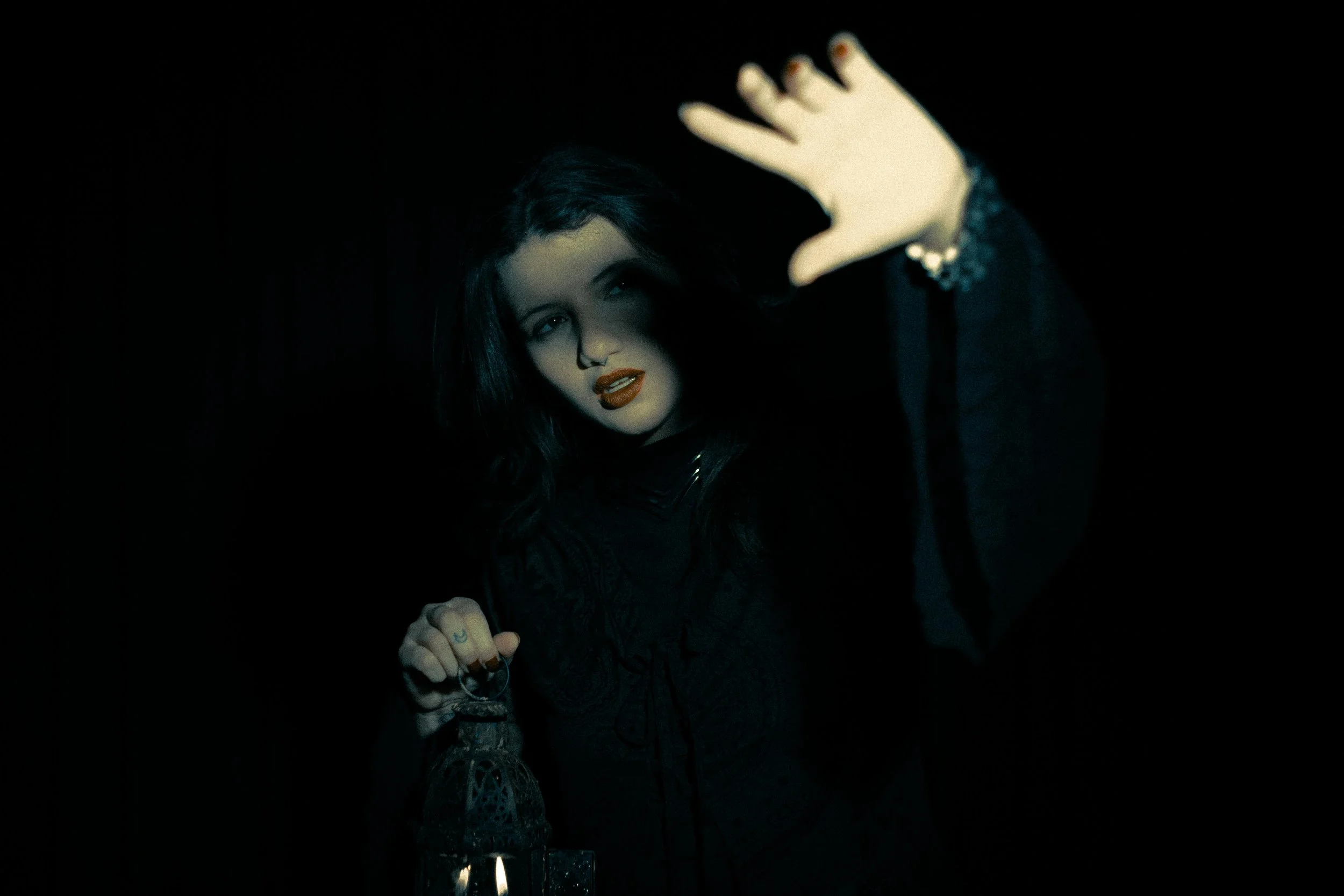 A symbolic scene showing a person emerging from darkness with a lantern, representing the work of exploring hidden parts of the self in psychodynamic therapy.