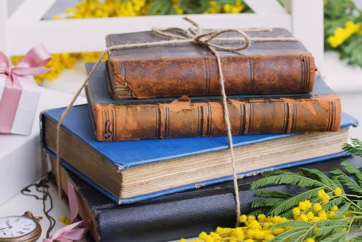 colorful books wrapped in twine