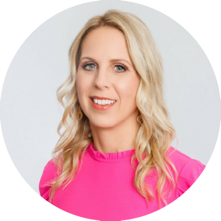 Smiling woman with long, wavy blonde hair wearing a bright pink blouse against a light background.