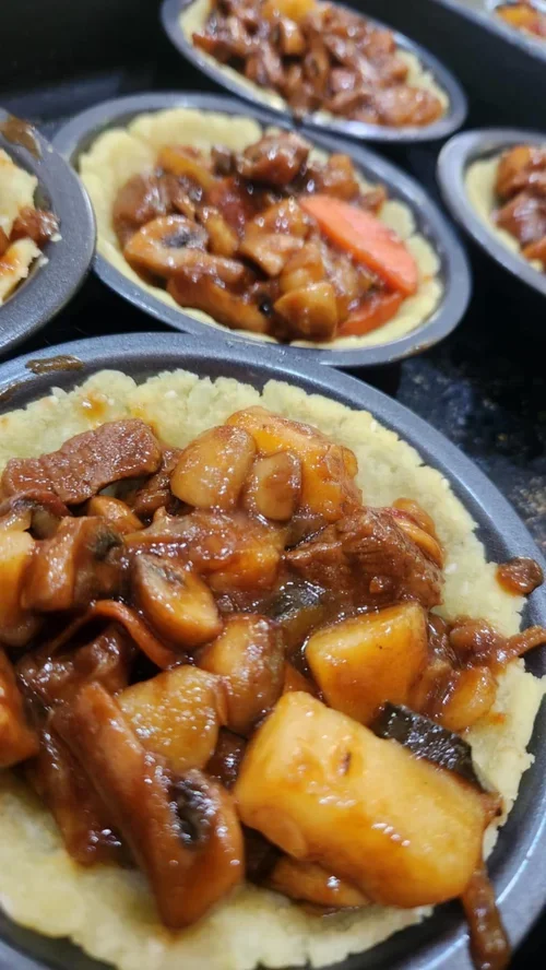 Preparing pie fillings with gravy beef mix.webp