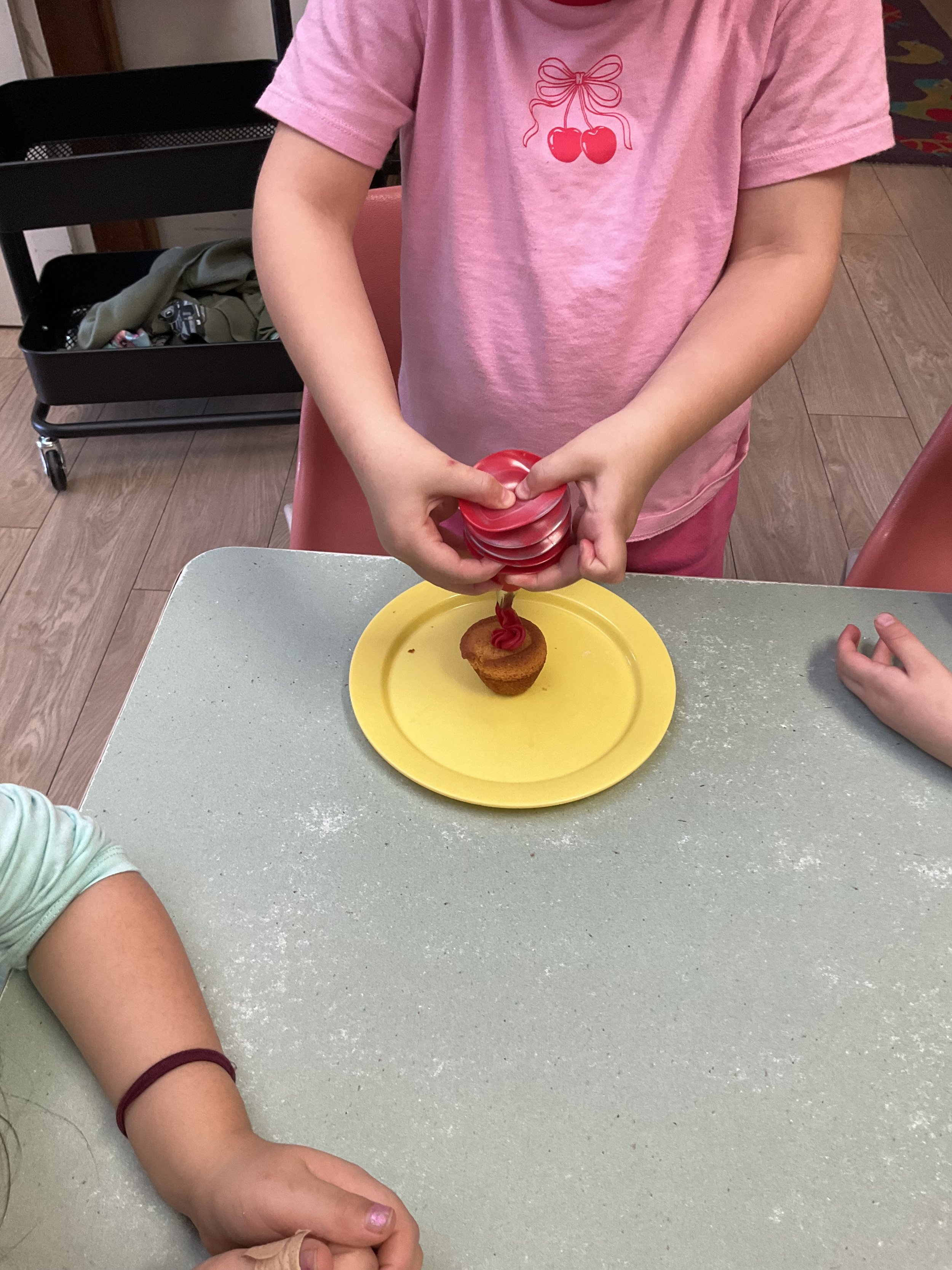 Piping frosting on our ANZAC Poppy Cupcakes