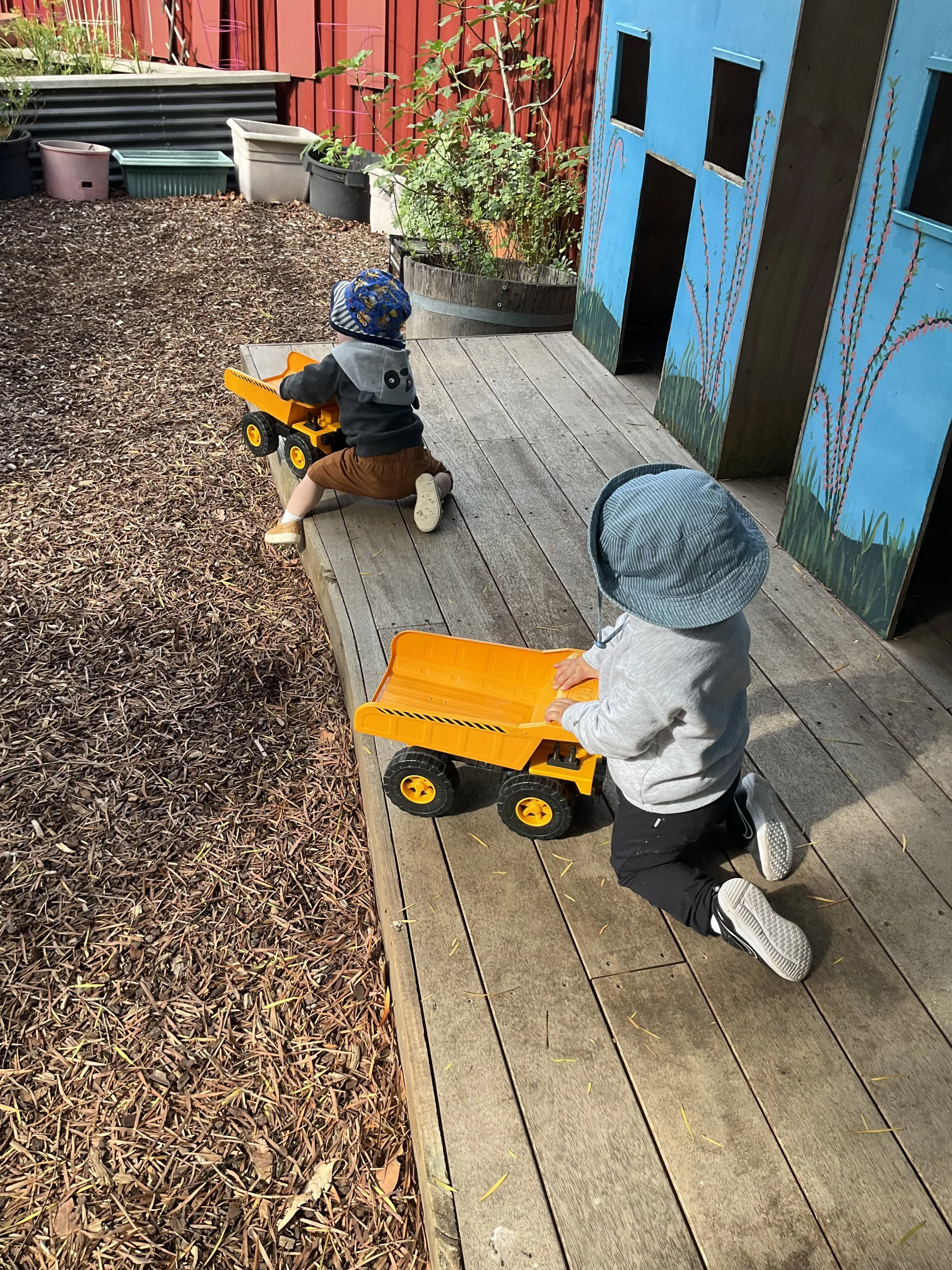 Playing with big yellow trucks outside