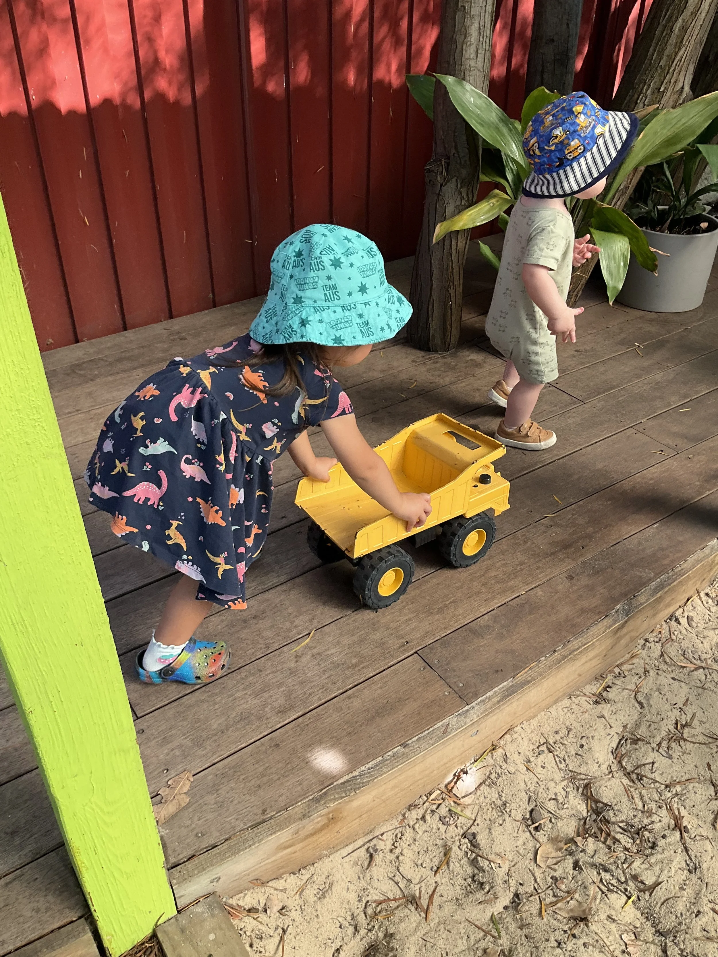 Playing with a big yellow truck outside