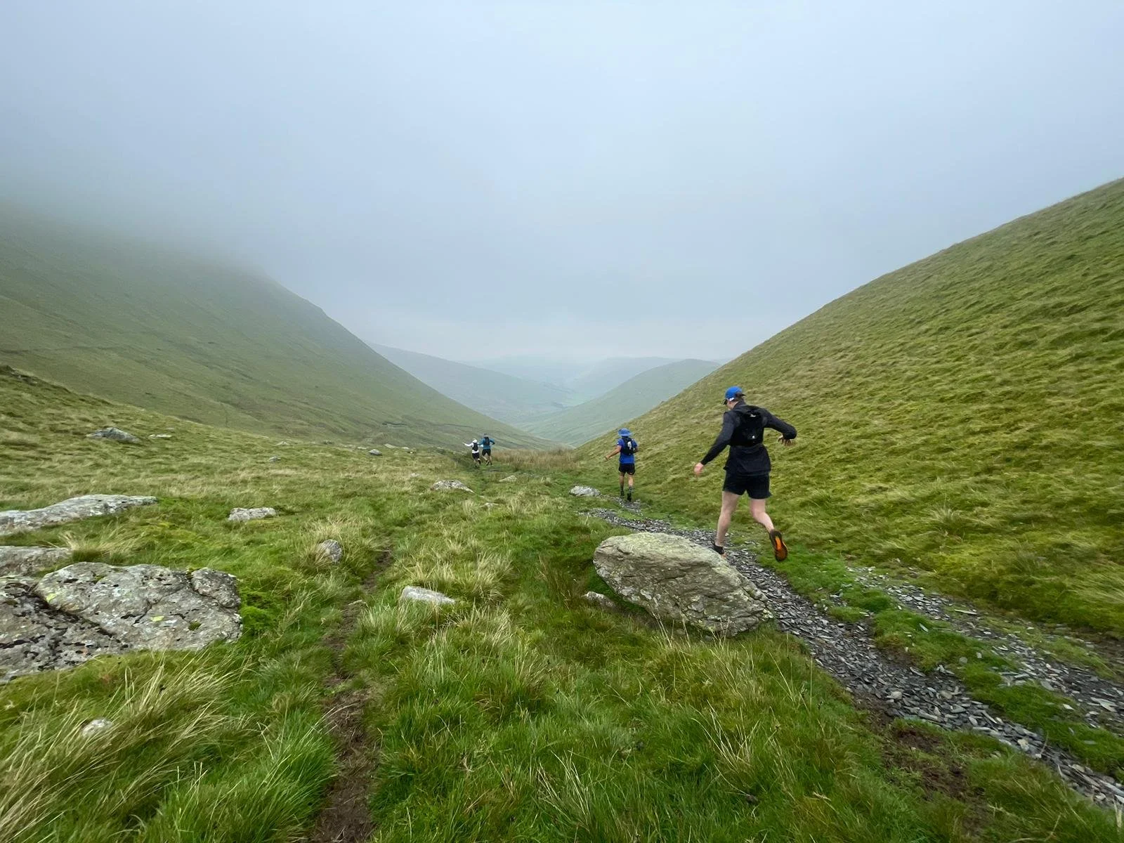 A group of runners running down a mountain in North Wales