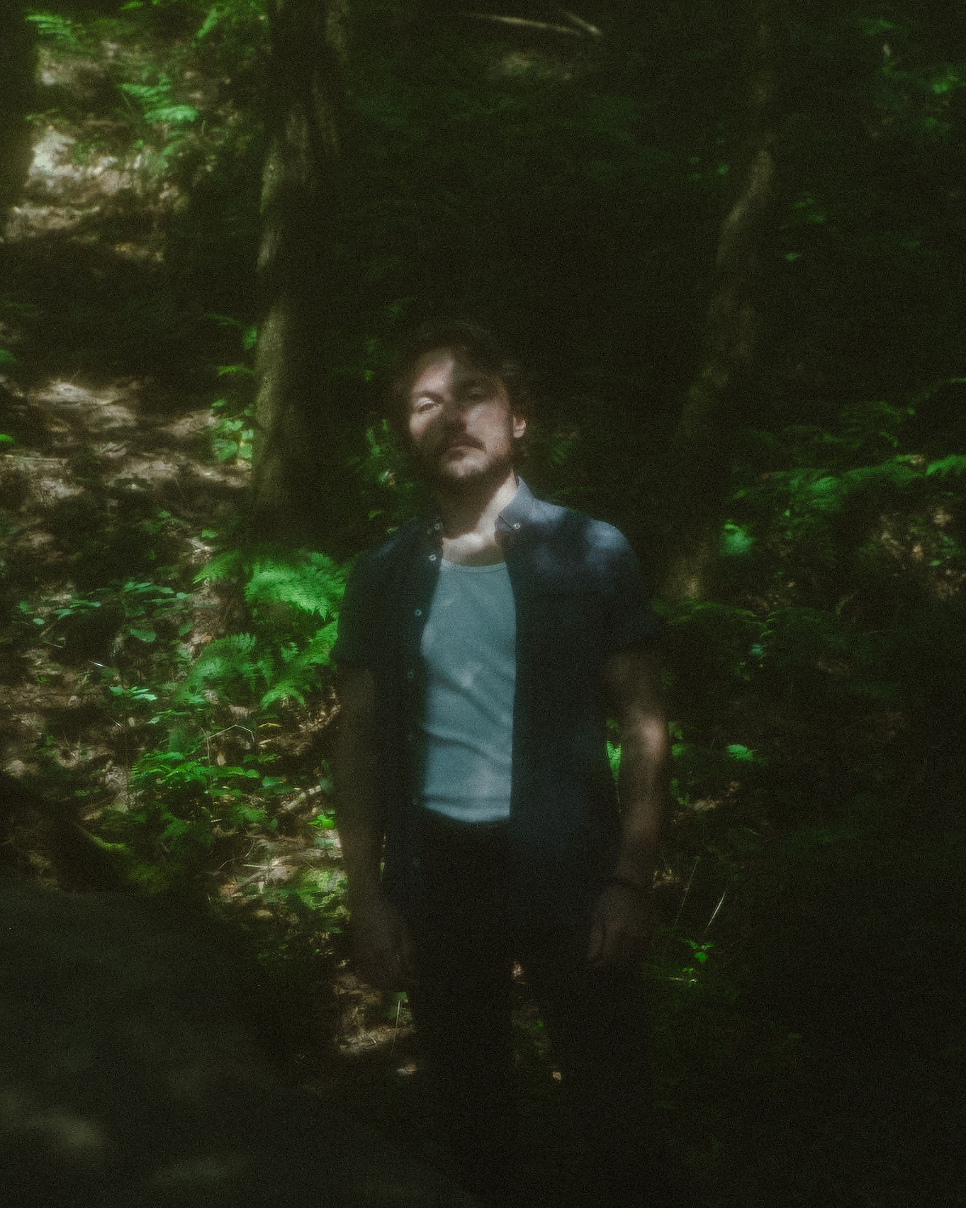 Official photo of Cam Clark, standing in an ethereal forest, from The Outer Reaches era.