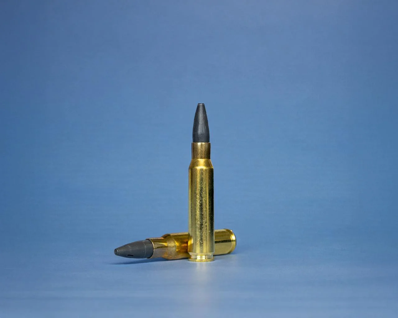 Two 7.62x51 SHATTER4K rounds, one standing upright and the other lying horizontally, displayed on a neutral background