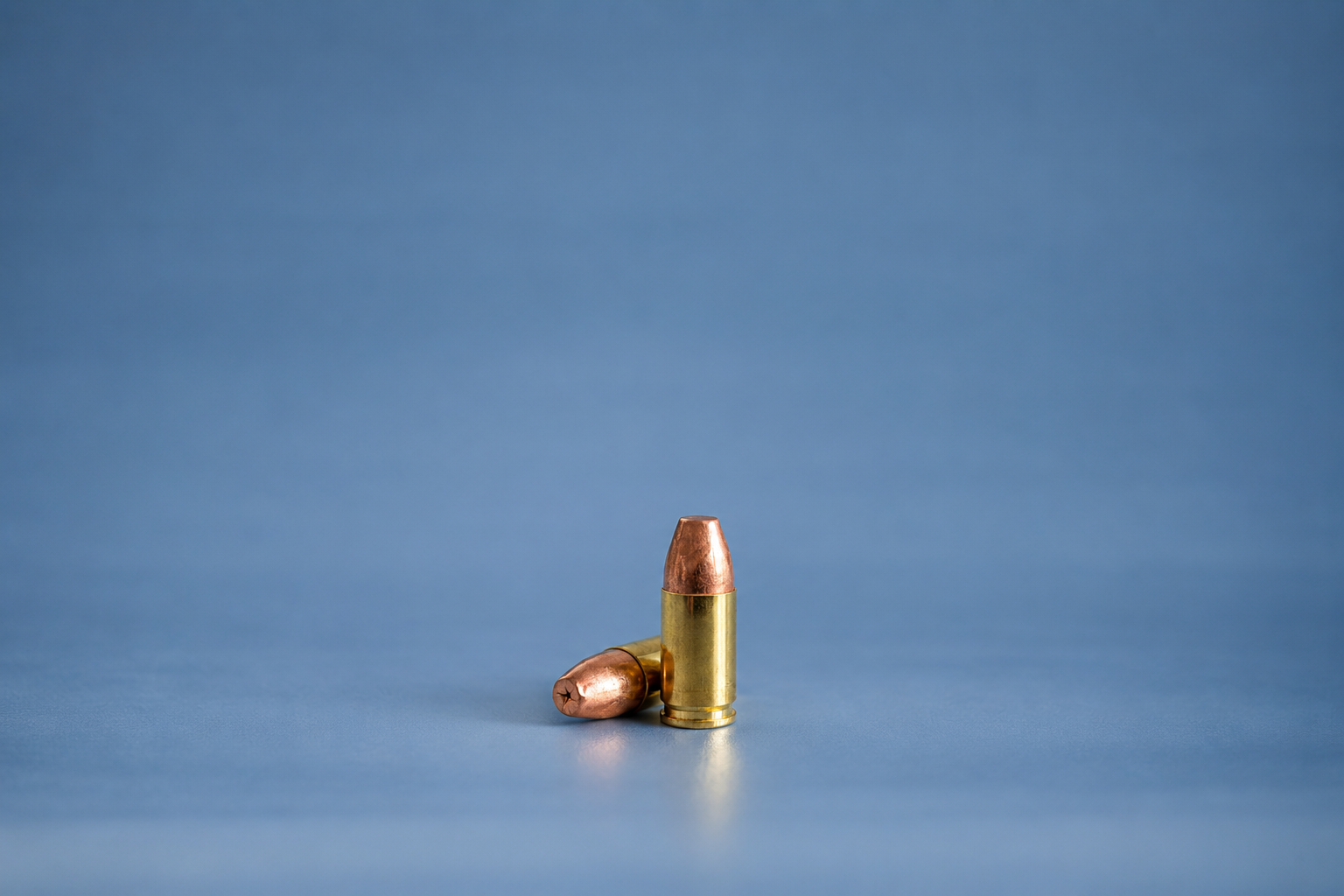 Two 9x19 MHP LF rounds, one standing upright and the other lying horizontally, displayed on a neutral background