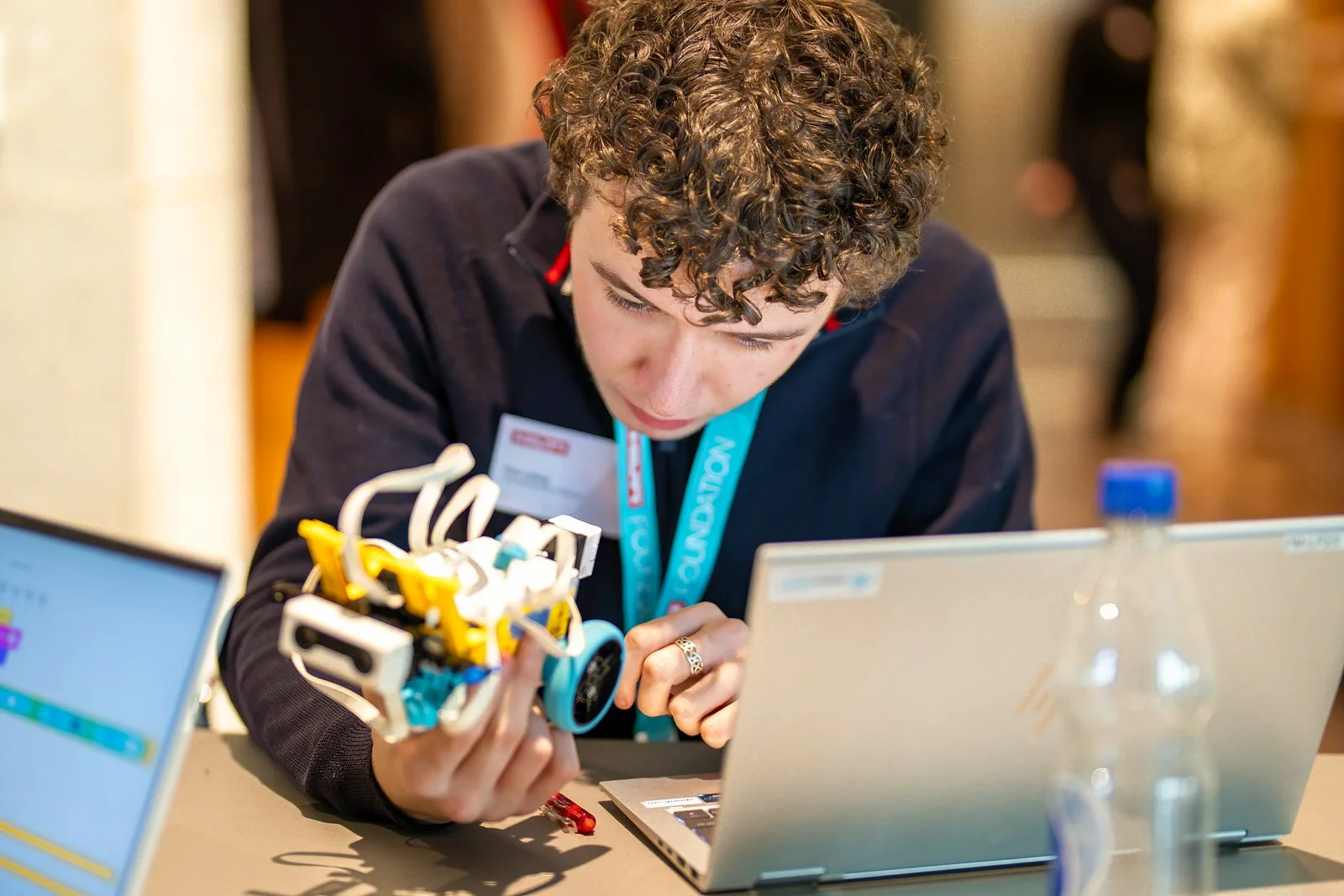 A student works with a robot at pepperMINT.