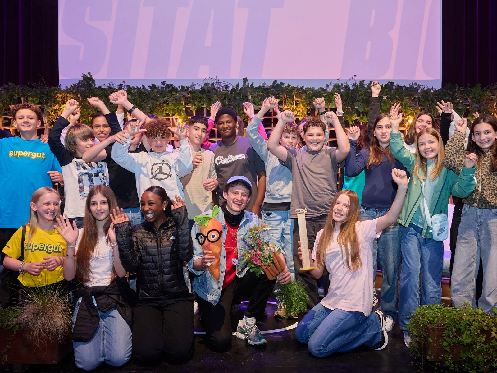 The winning Liechtenstein school class poses with their award and Checker Julian at the Tatort Biodiversity event.