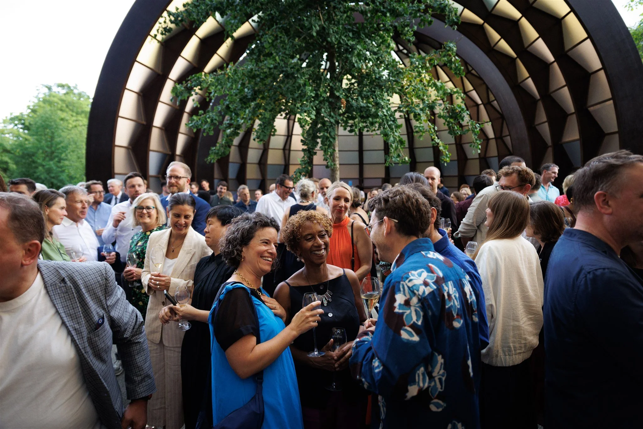 Guests mingle beneath sculptural architecture at a London awards celebration, capturing the atmosphere of a cultural industry event.