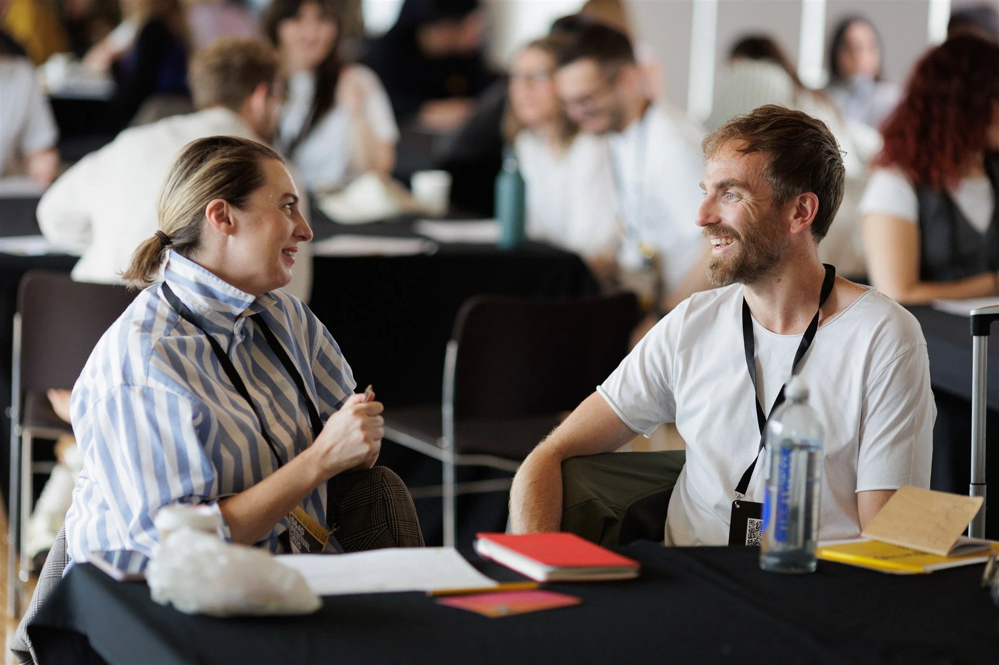 Candid event photography of two masterclass attendees talking