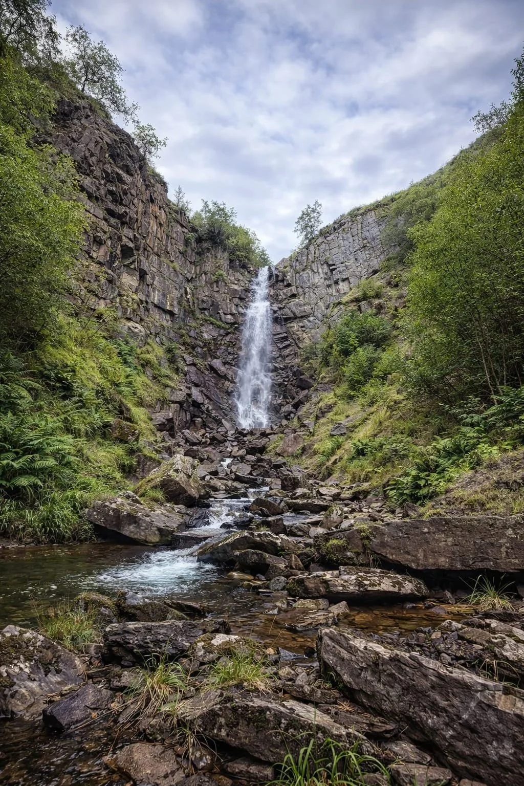 Ffrwd Fawr Waterfall in the Pennant Valley near Llanbrynmair, a tall 40-metre cascade dropping into a rocky gorge surrounded by peaceful Mid Wales scenery, close to Coety Bach.